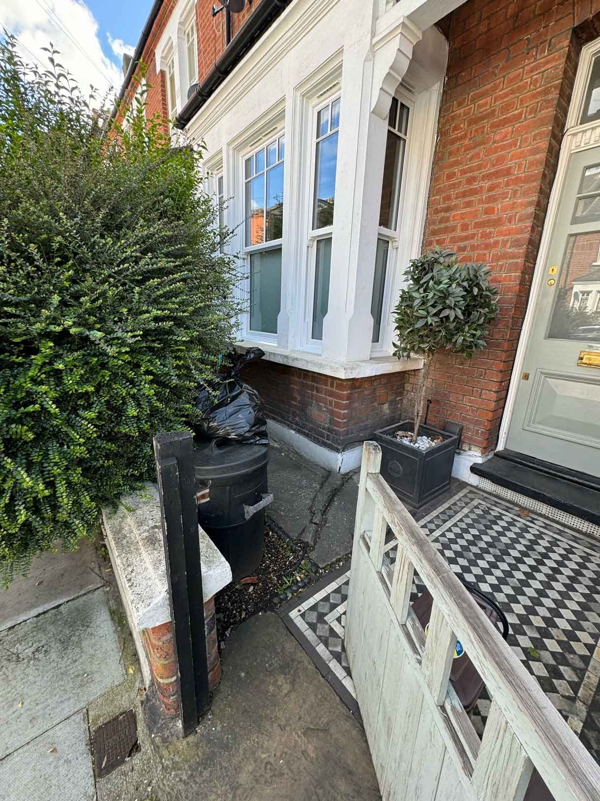 Front garden in Battersea with black porcelain tiles