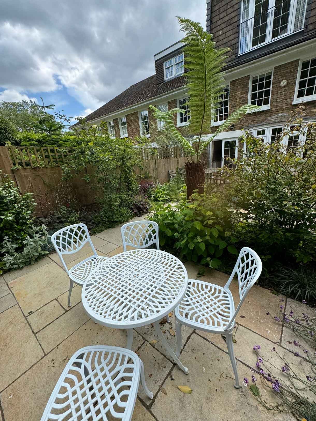 Courtyard garden in Putney with lots of plants.