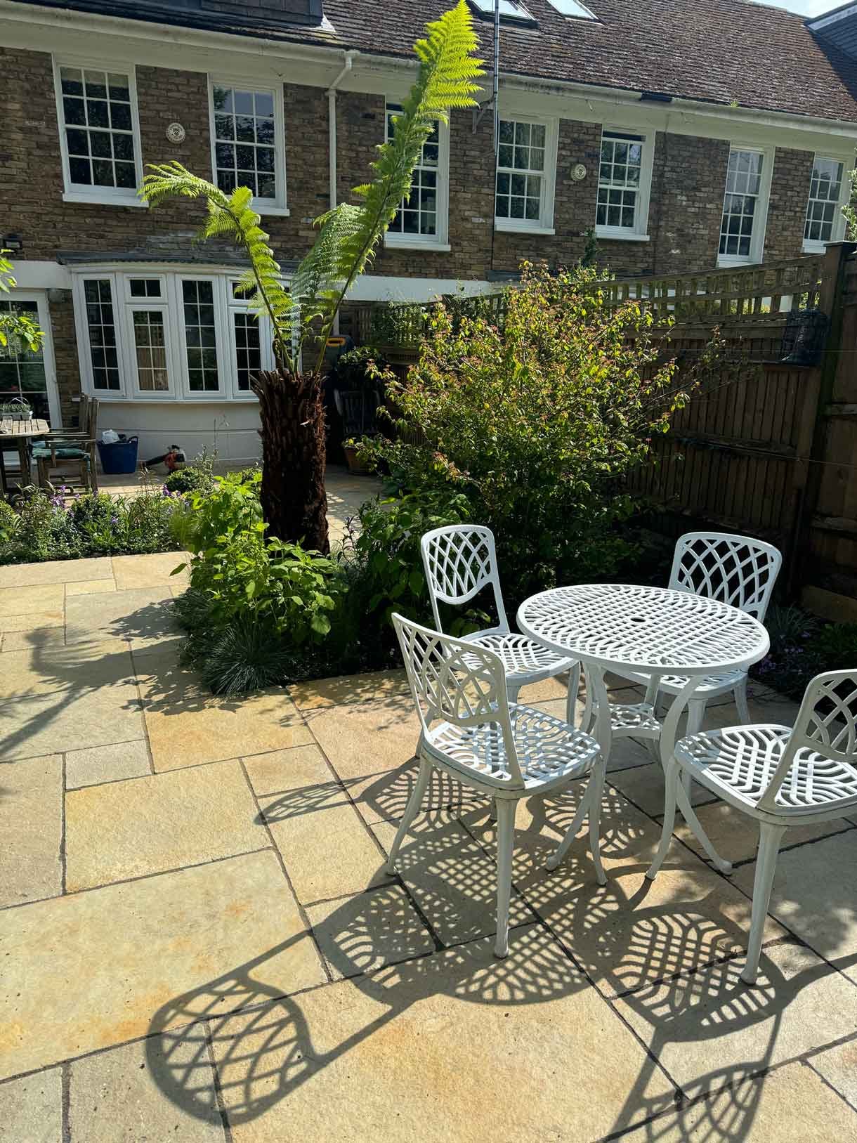 Courtyard garden in Putney with lots of plants.