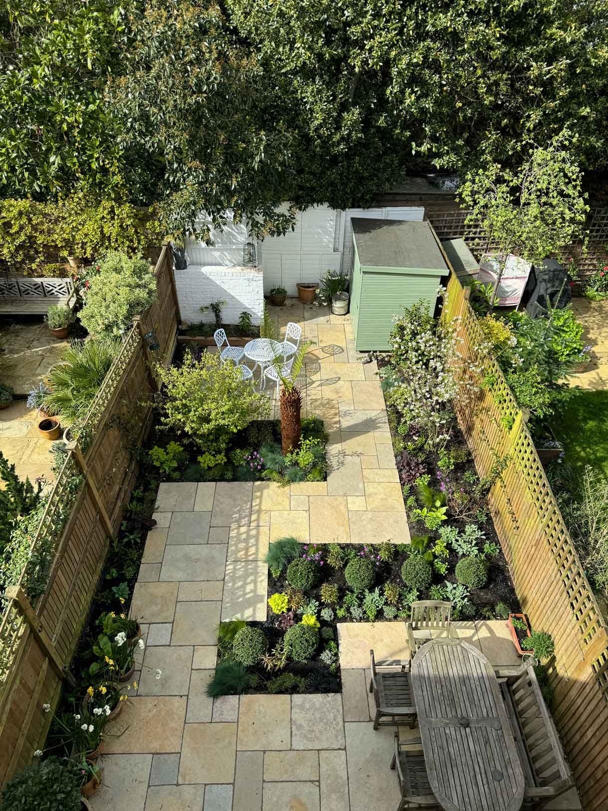 Courtyard garden in Putney with lots of plants.