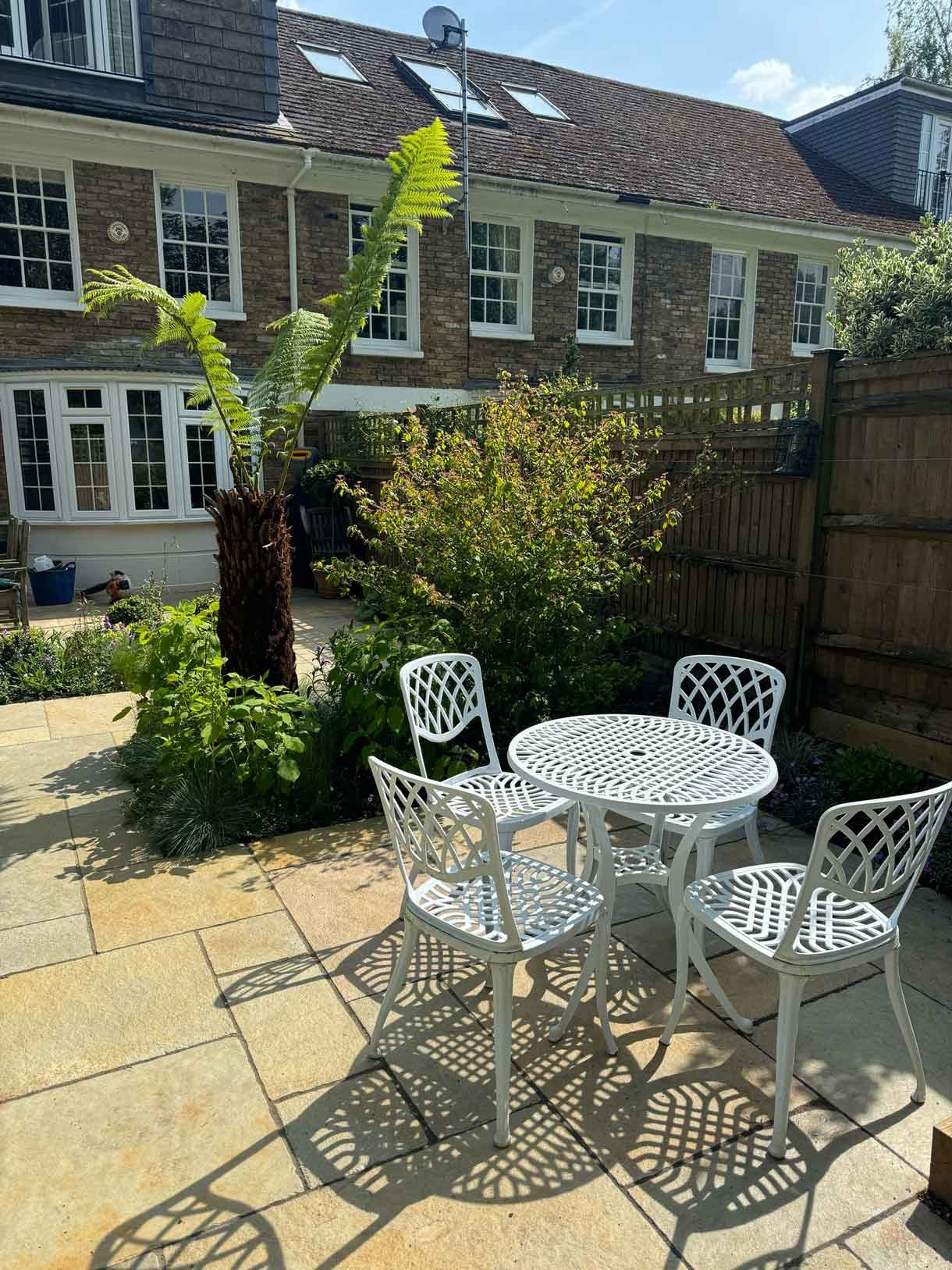 Courtyard garden in Putney with lots of plants.