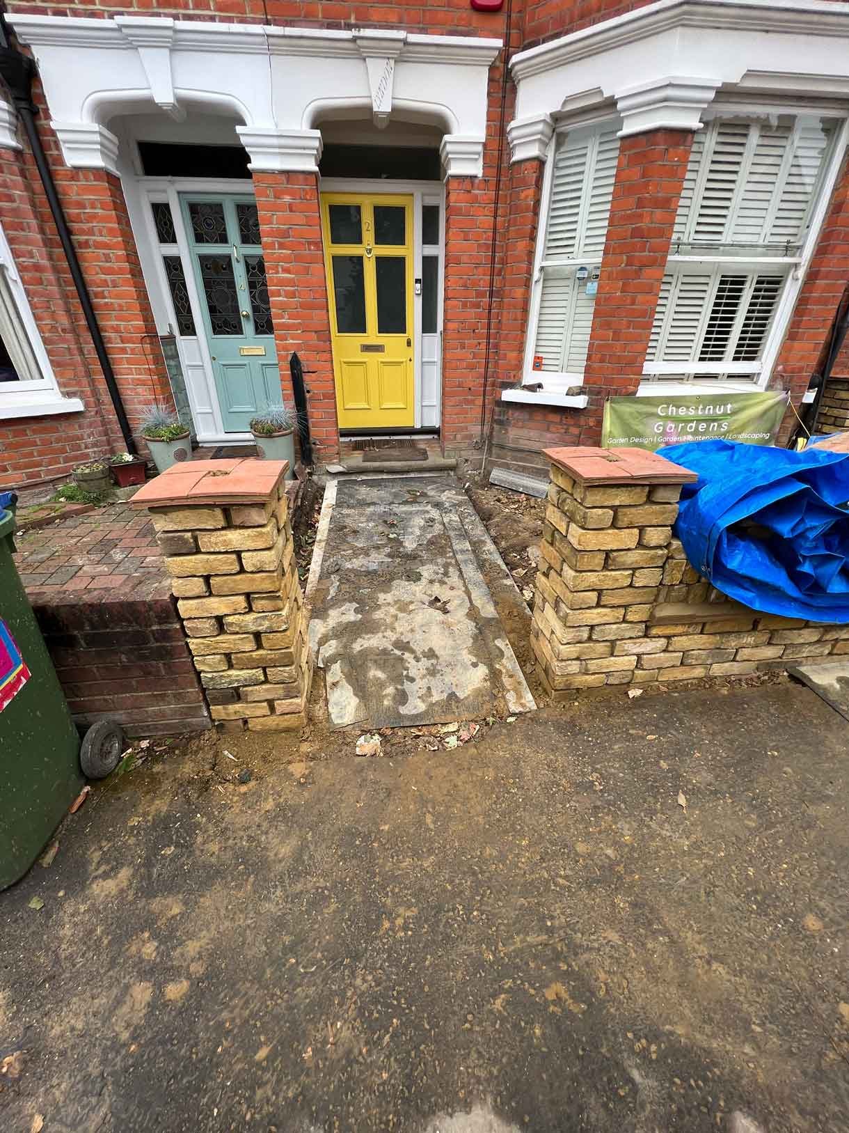 Brick columns being built for the front of the house brick wall