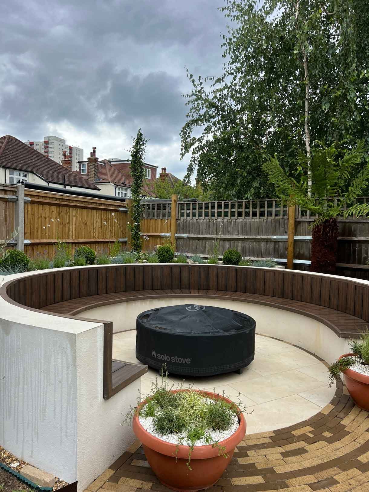 A circular bench created for our client from rendered concrete blocks and composite decking