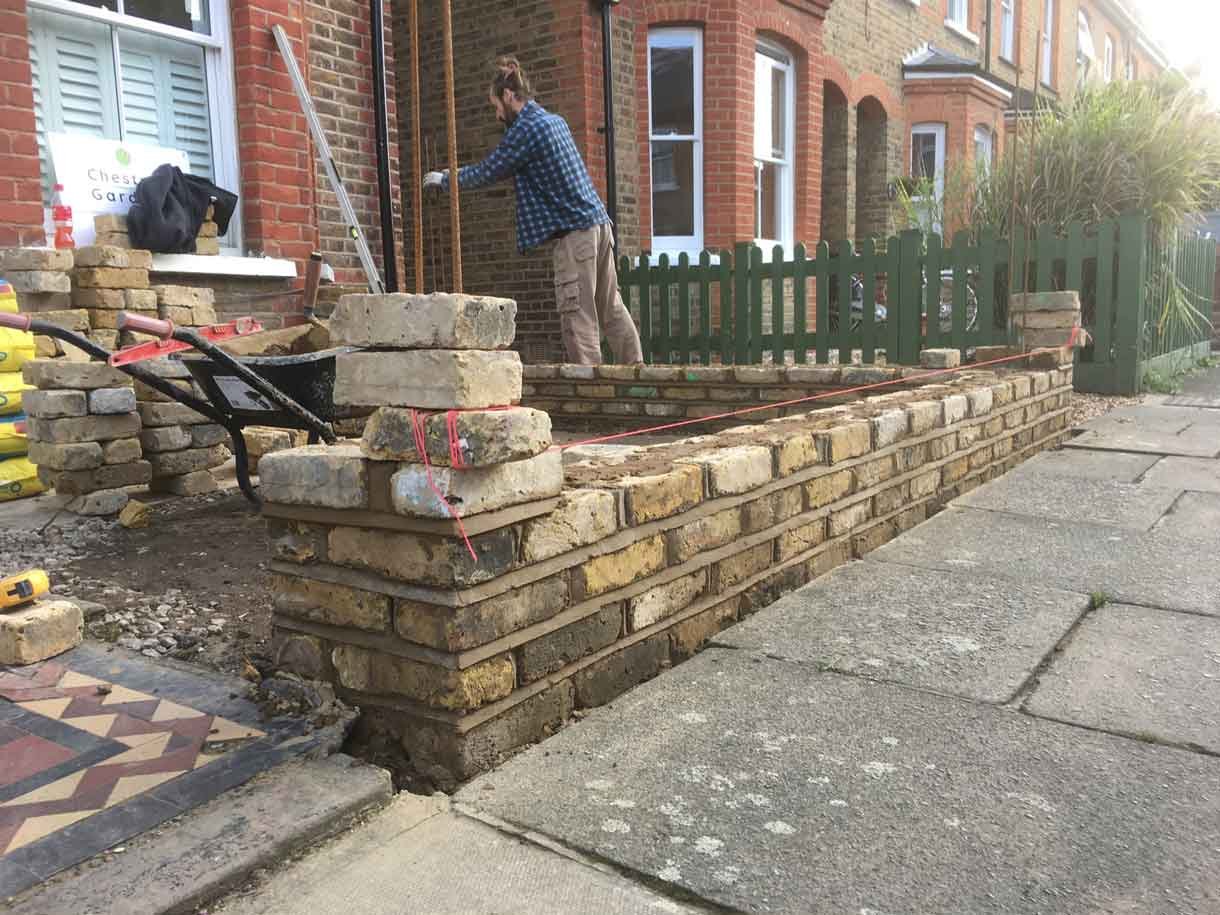 The brick wall being constructed