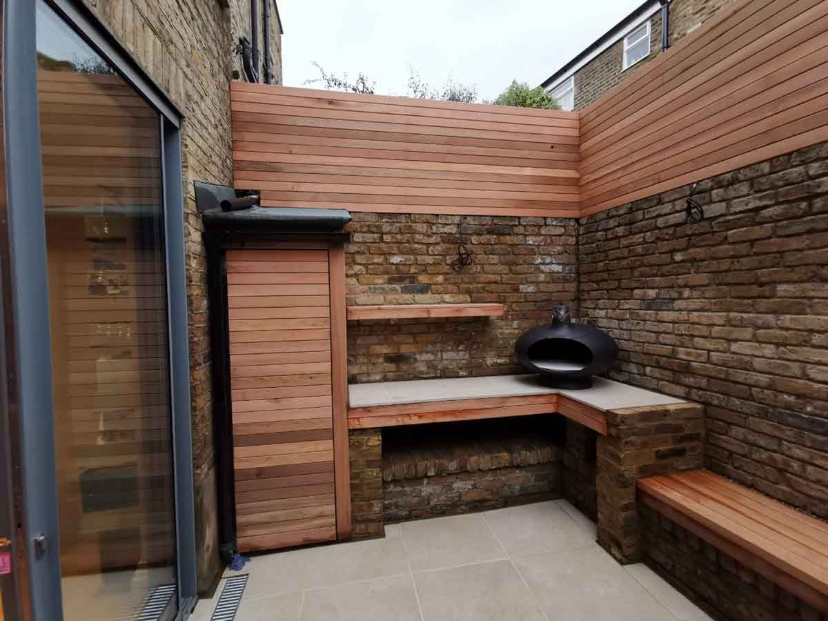 A small courtyard garden in Chiswick, using cedar battens for the fencing and porcelain tiles for the patio area.