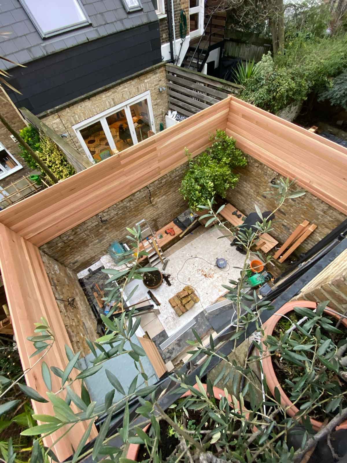 A small courtyard garden in Chiswick, using cedar battens for the fencing and porcelain tiles for the patio area.