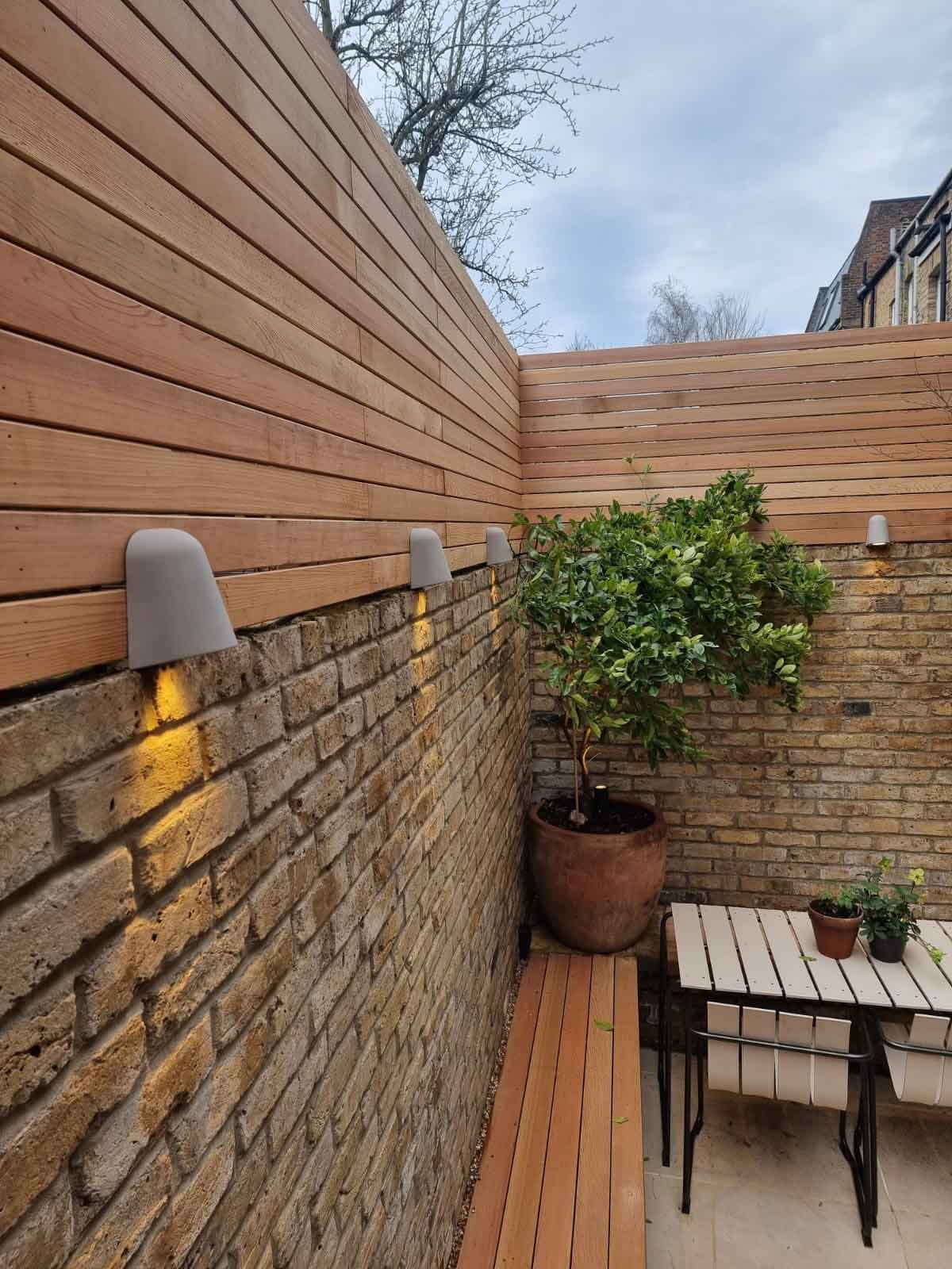 A small courtyard garden in Chiswick, using cedar battens for the fencing and porcelain tiles for the patio area.