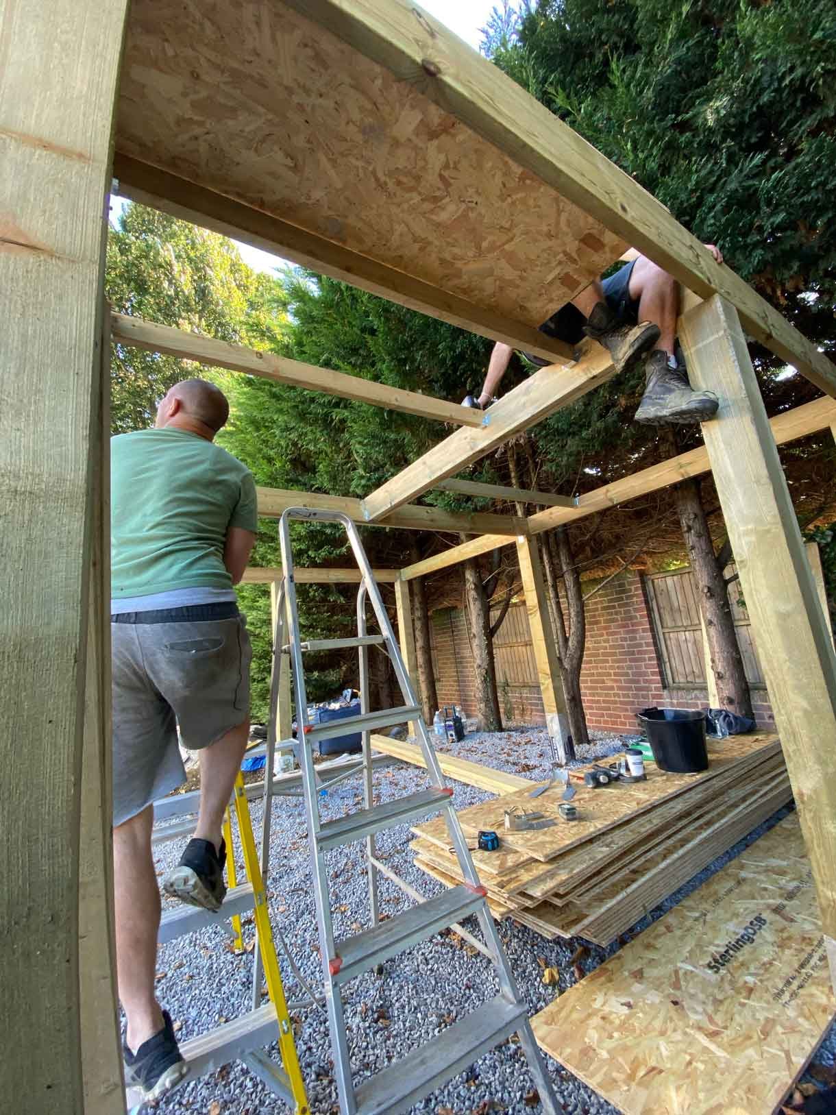 Construction work on the wooden car port structure