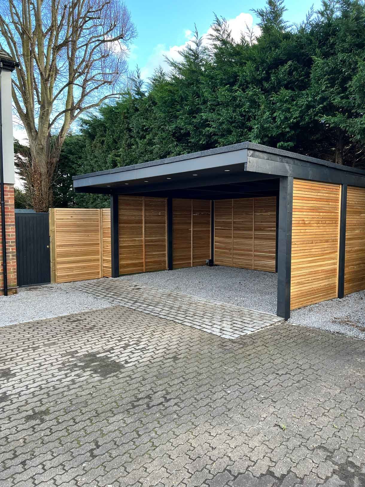 A carport made from Siberian larch panels and a gravel drive to house the clients vehicles.