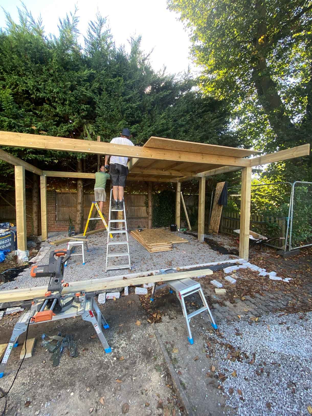 Construction work on the wooden car port structure