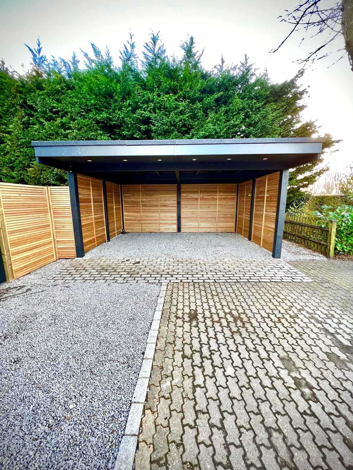 A carport made from Siberian larch panels and a gravel drive to house the clients vehicles.