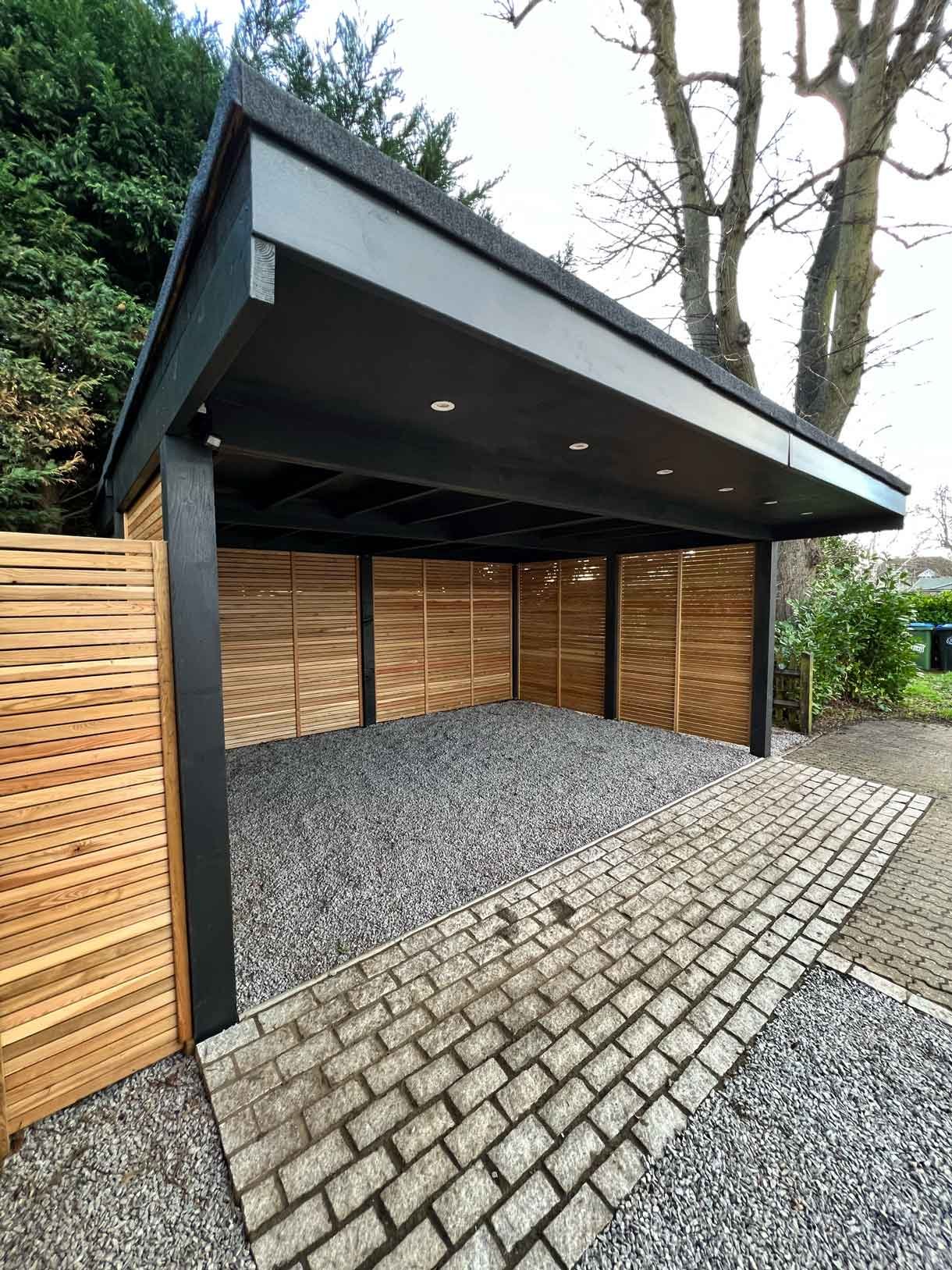 A carport made from Siberian larch panels and a gravel drive to house the clients vehicles.