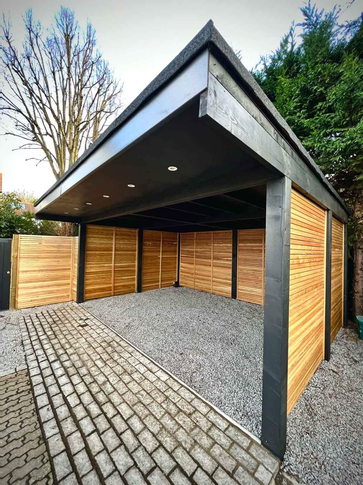 A carport made from Siberian larch panels and a gravel drive to house the clients vehicles.
