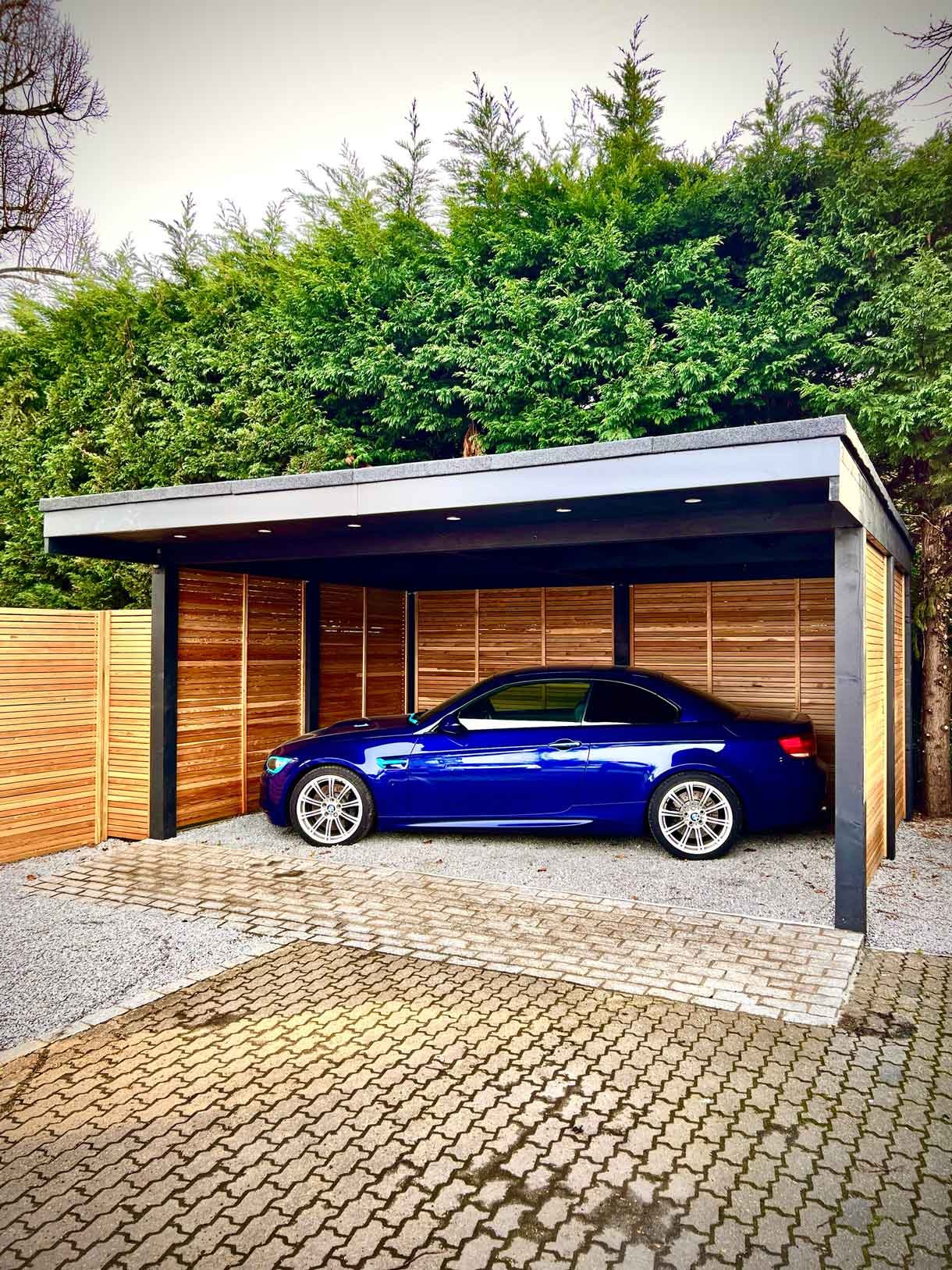 A carport made from Siberian larch panels and a gravel drive to house the clients vehicles.