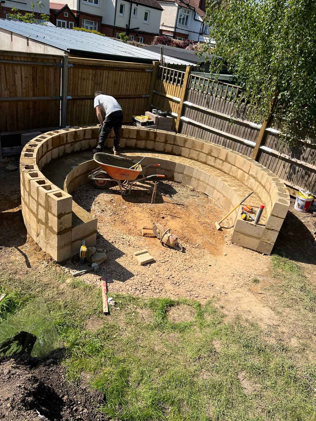 Construction images of a landscaping project of a circular bench.
