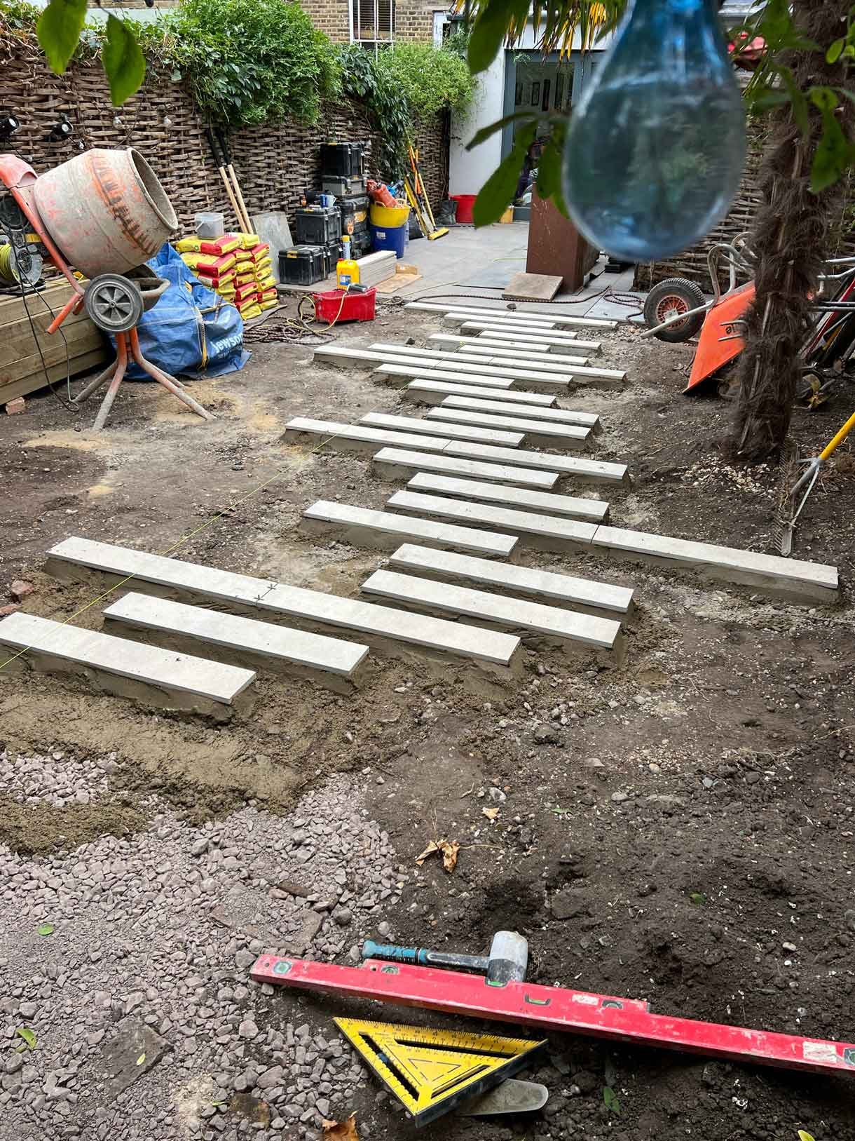 Construction images of a landscaping project of a circular bench.