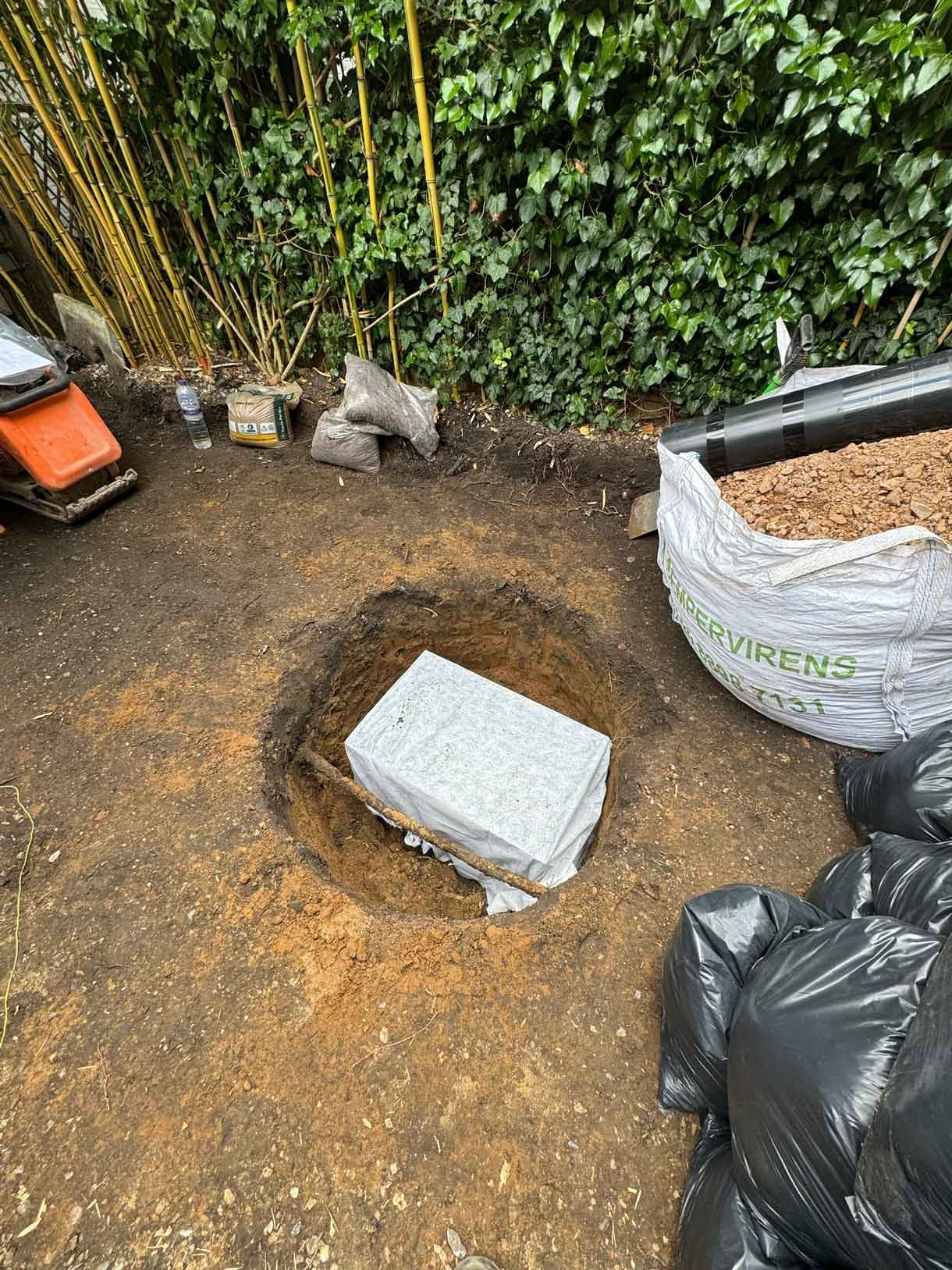 Image of a large hole in the ground with a soak away installed