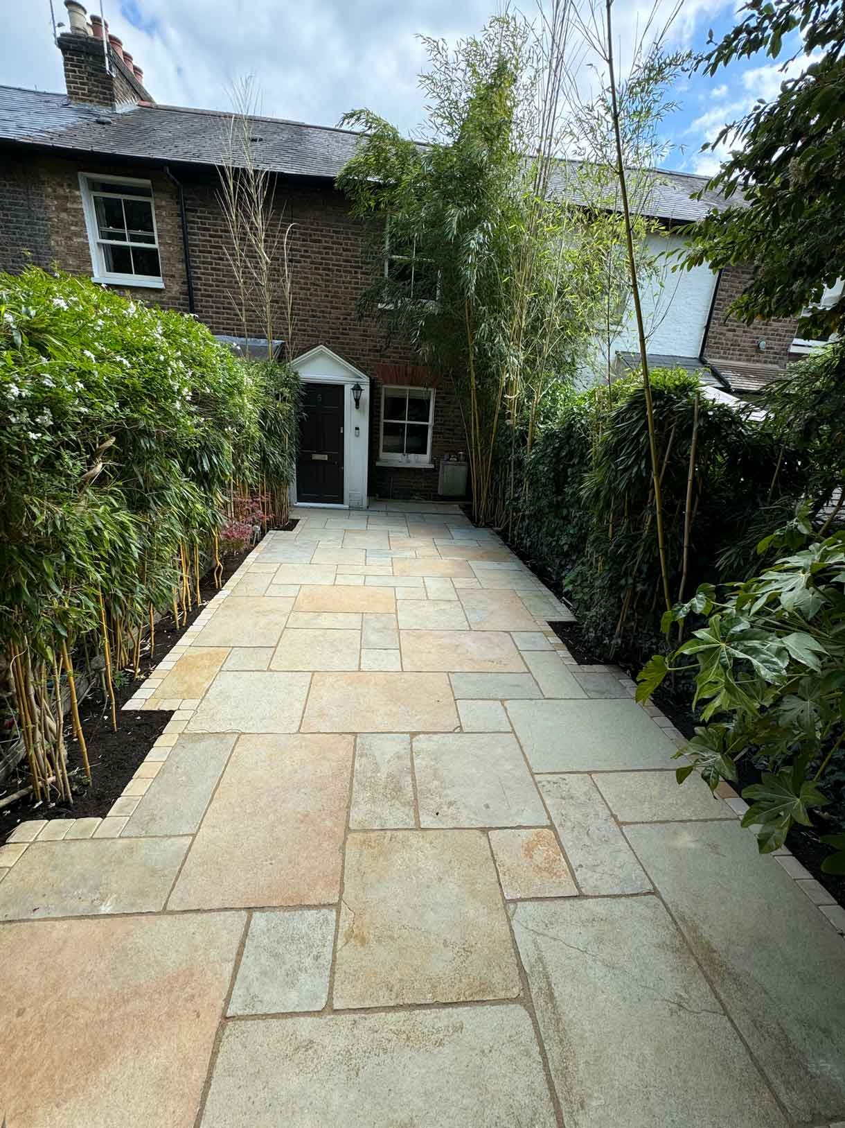 A new limestone patio in the project pack pattern. Beige and warm yellow colours.