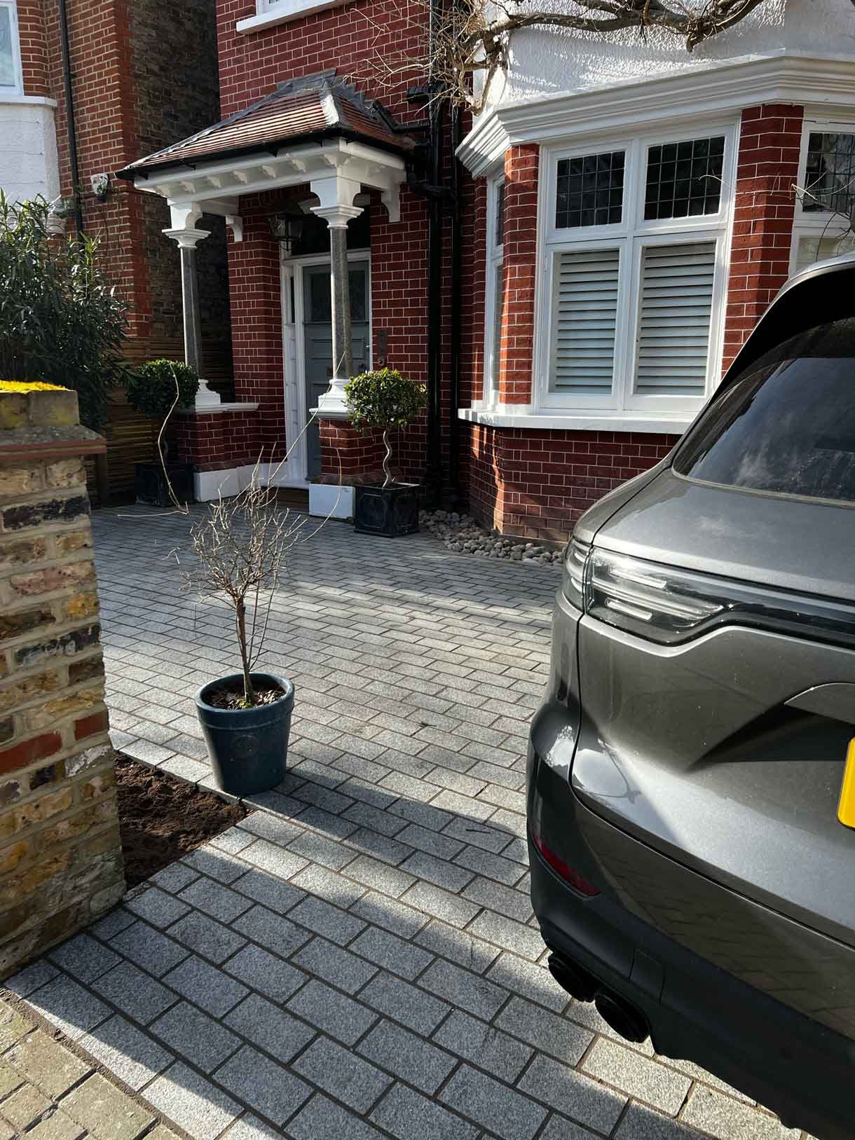 A driveway made from granite setts for this redbrick property in Putney.