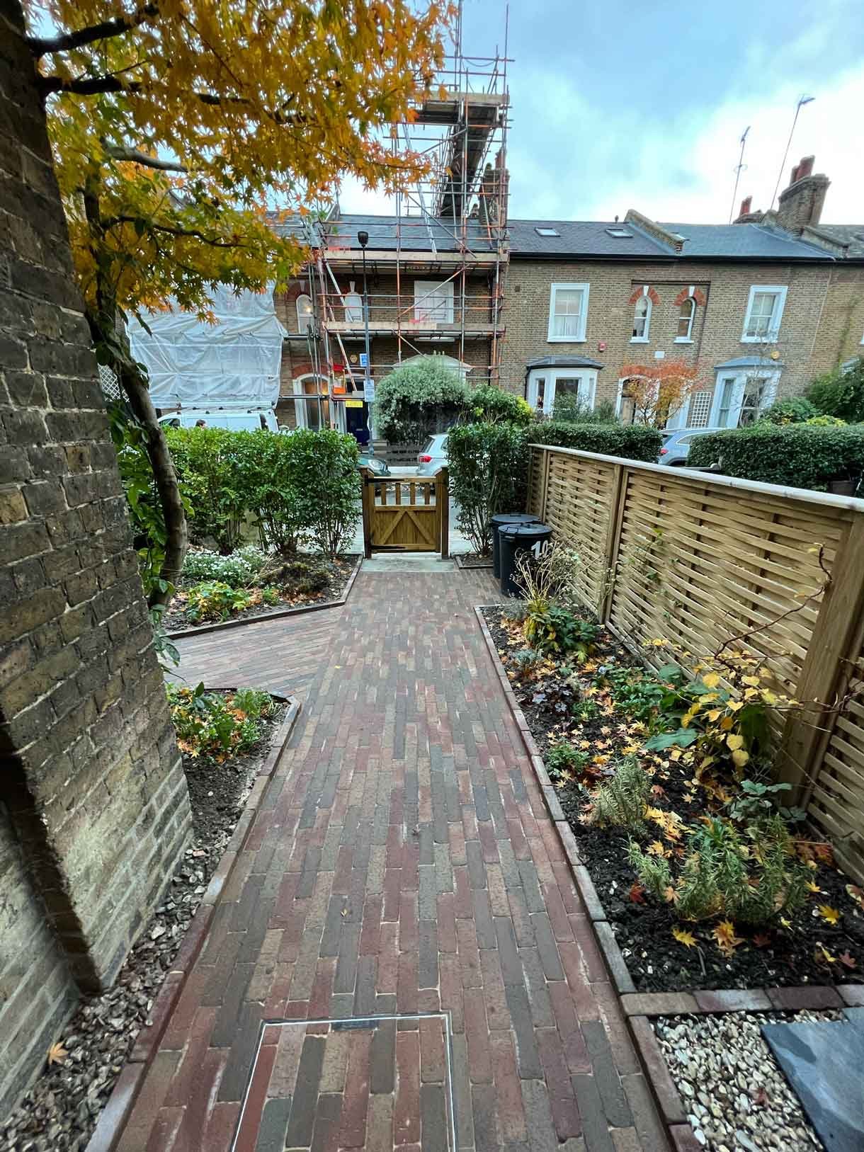 A clay paver path for the front of a listed house in Hammersmith, using warm red tones for the clay pavers.