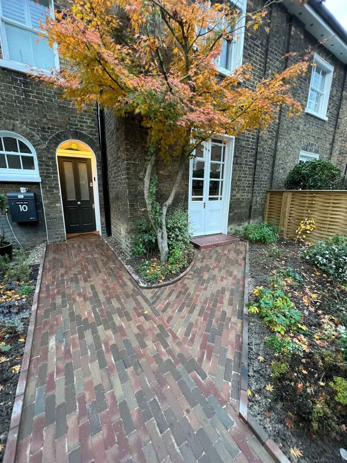 A clay paver path for the front of a listed house in Hammersmith, using warm red tones for the clay pavers.