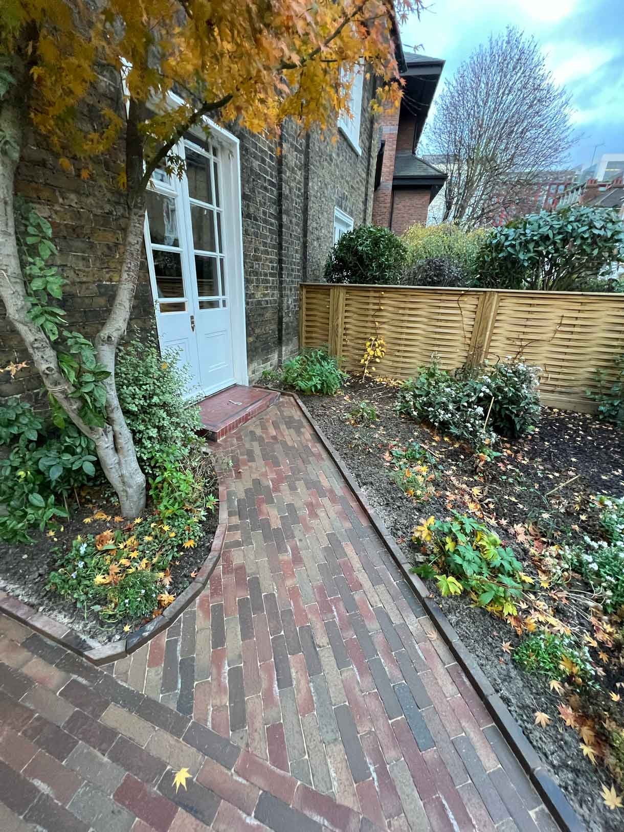A clay paver path for the front of a listed house in Hammersmith, using warm red tones for the clay pavers.
