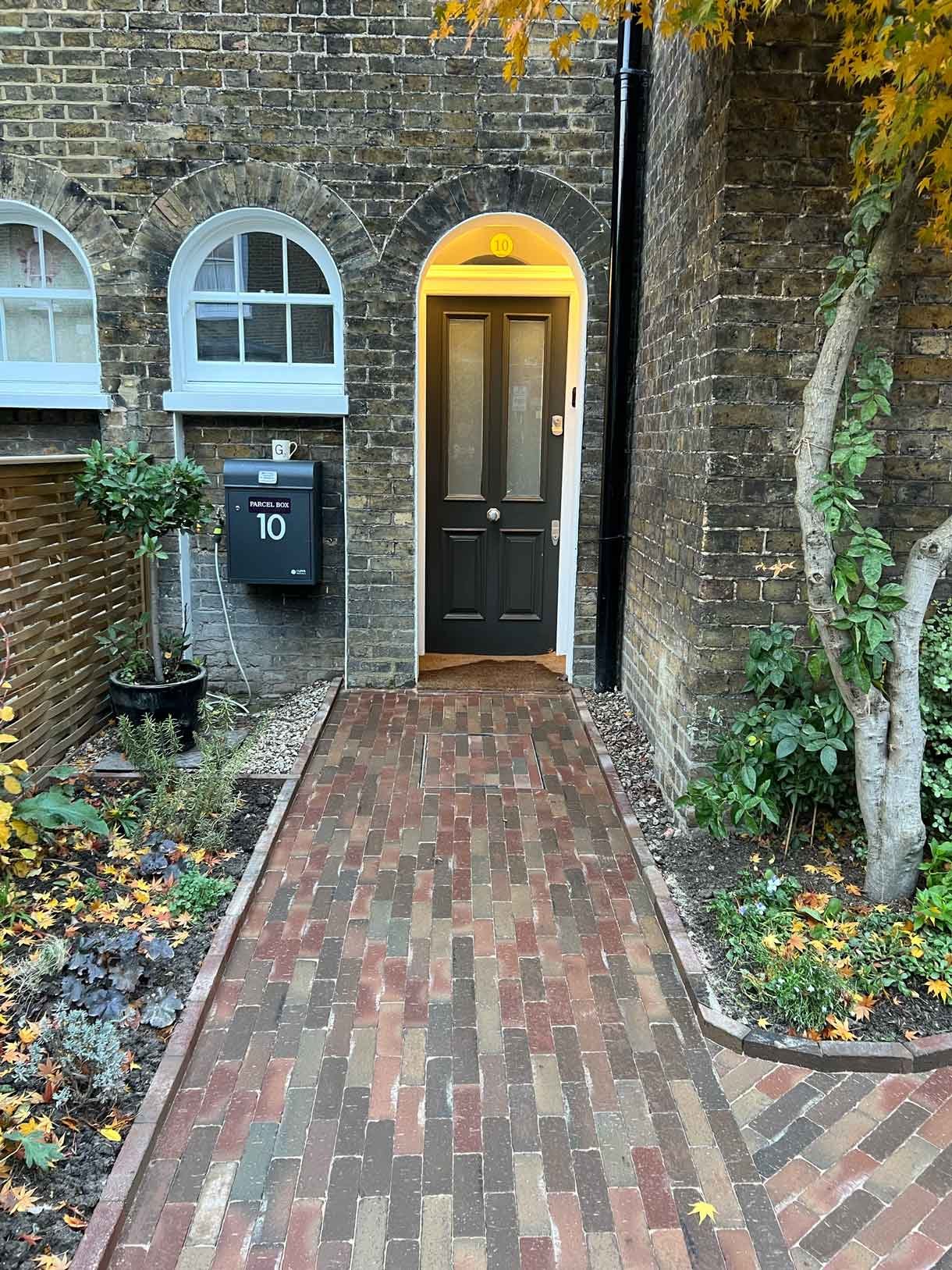 A clay paver path for the front of a listed house in Hammersmith, using warm red tones for the clay pavers.