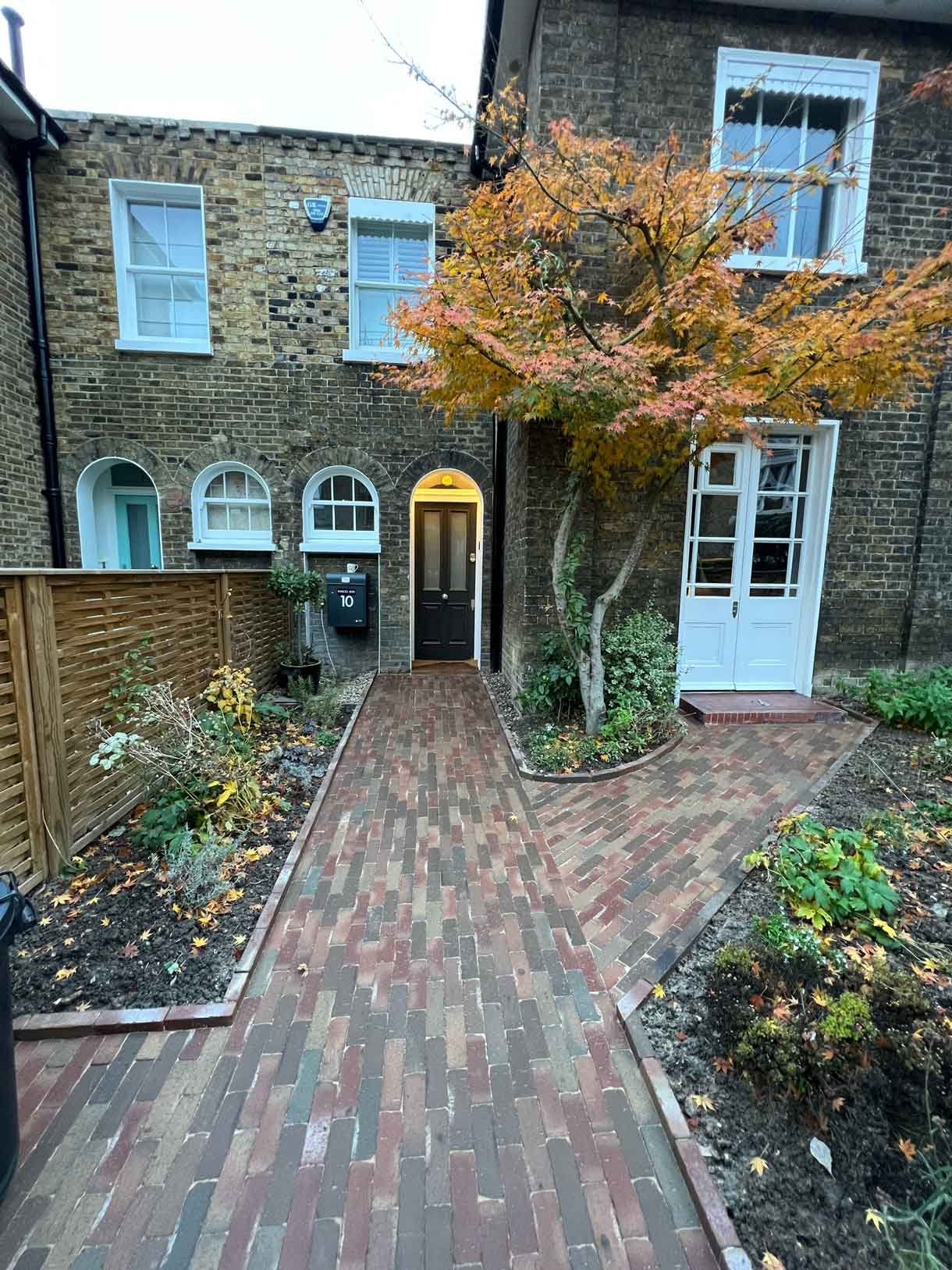 A clay paver path for the front of a listed house in Hammersmith, using warm red tones for the clay pavers.