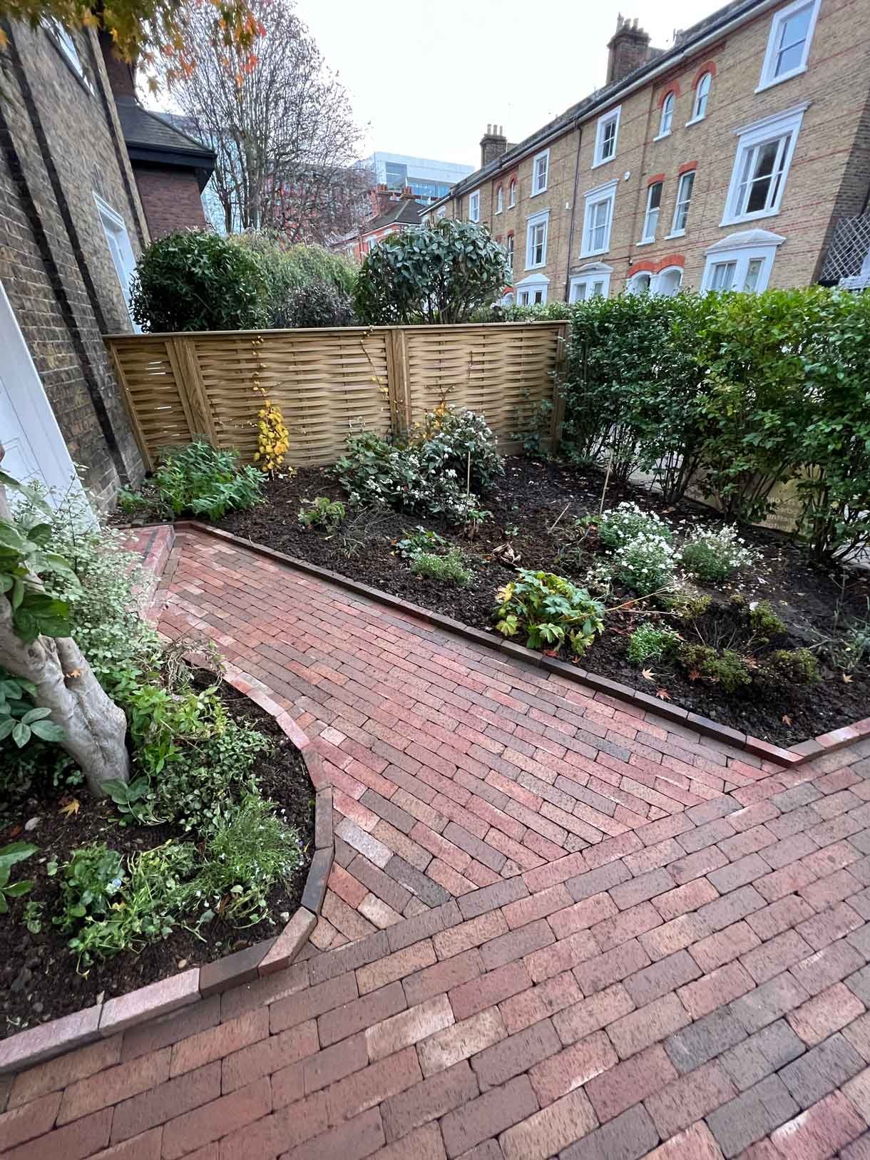 A clay paver path for the front of a listed house in Hammersmith, using warm red tones for the clay pavers.
