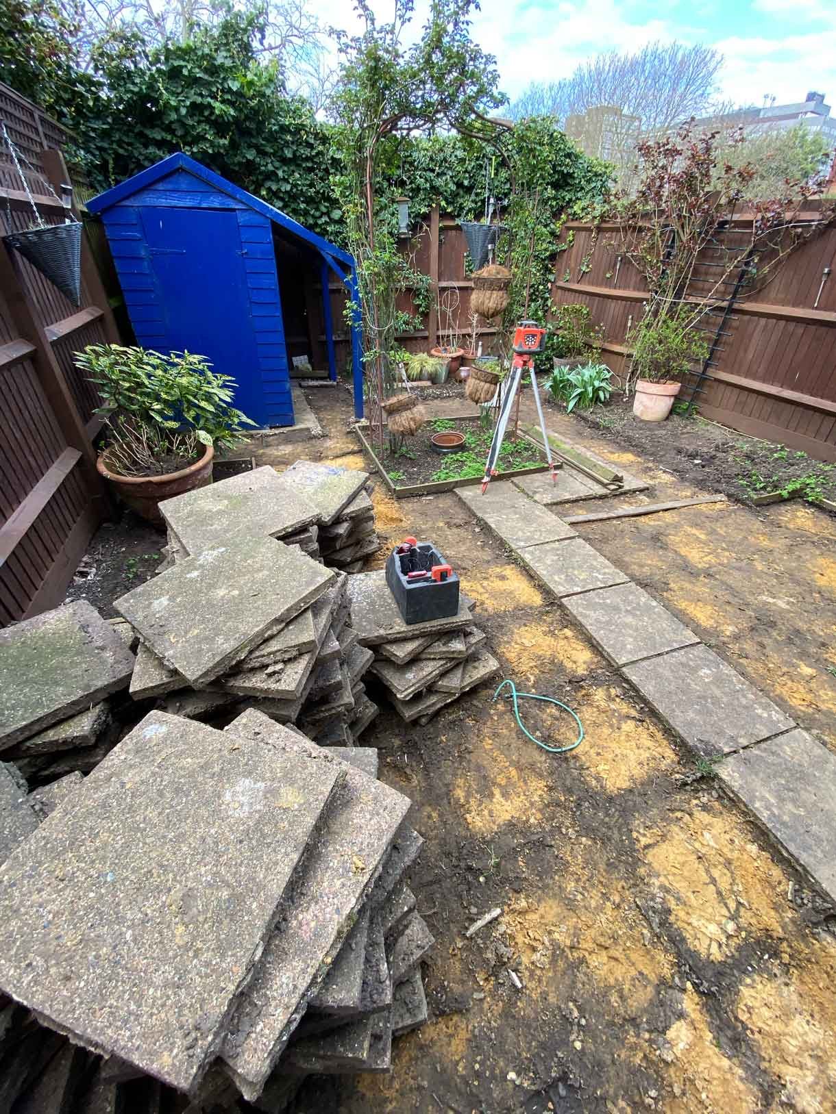 The courtyard garden before the transformation with old concrete tiles.