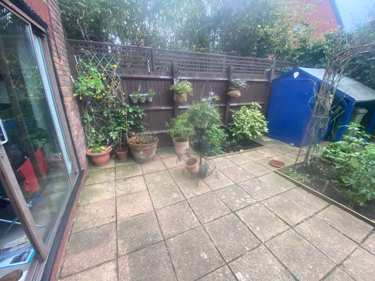 The courtyard garden before the transformation with old concrete tiles.