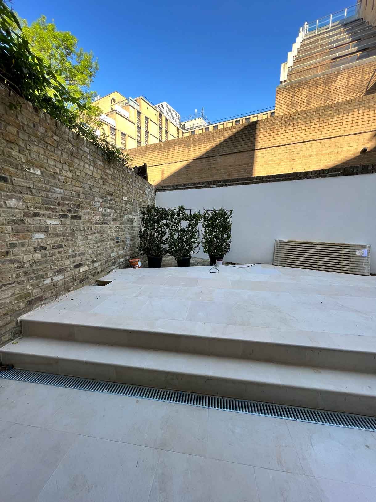 The small garden in need of some plants currently with bins and rubbish from the build in the garden and space.