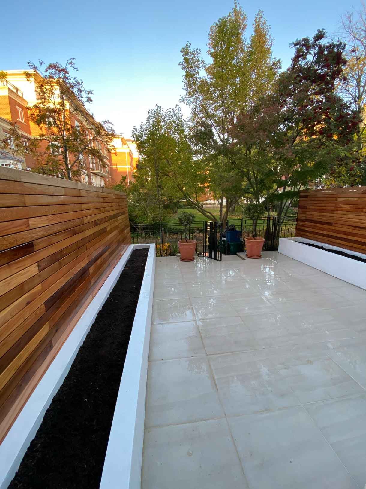 Courtyard garden in Richmond with white rendered planters and cedar fencing.