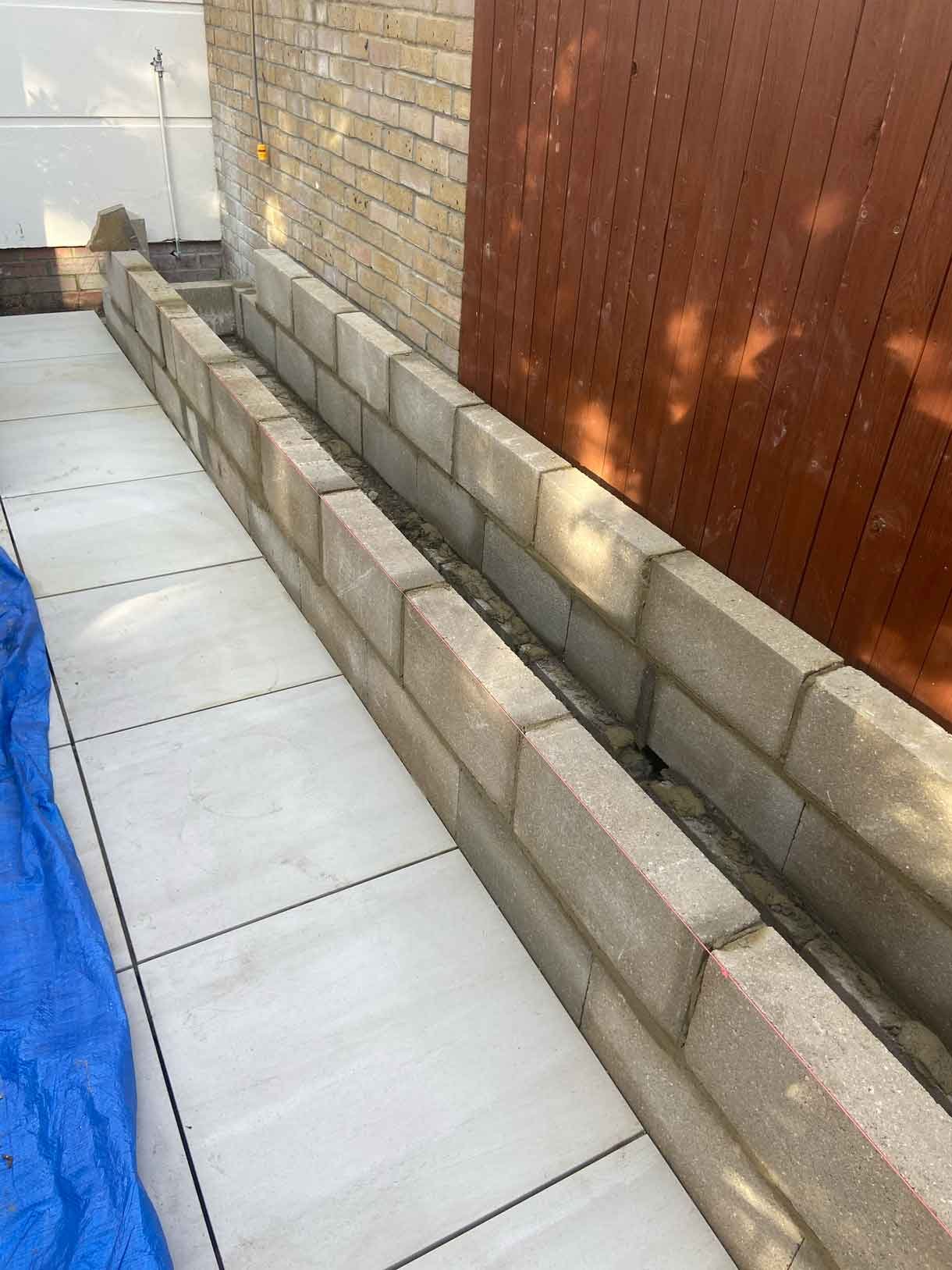 Courtyard garden in Richmond with white rendered planters and cedar fencing.