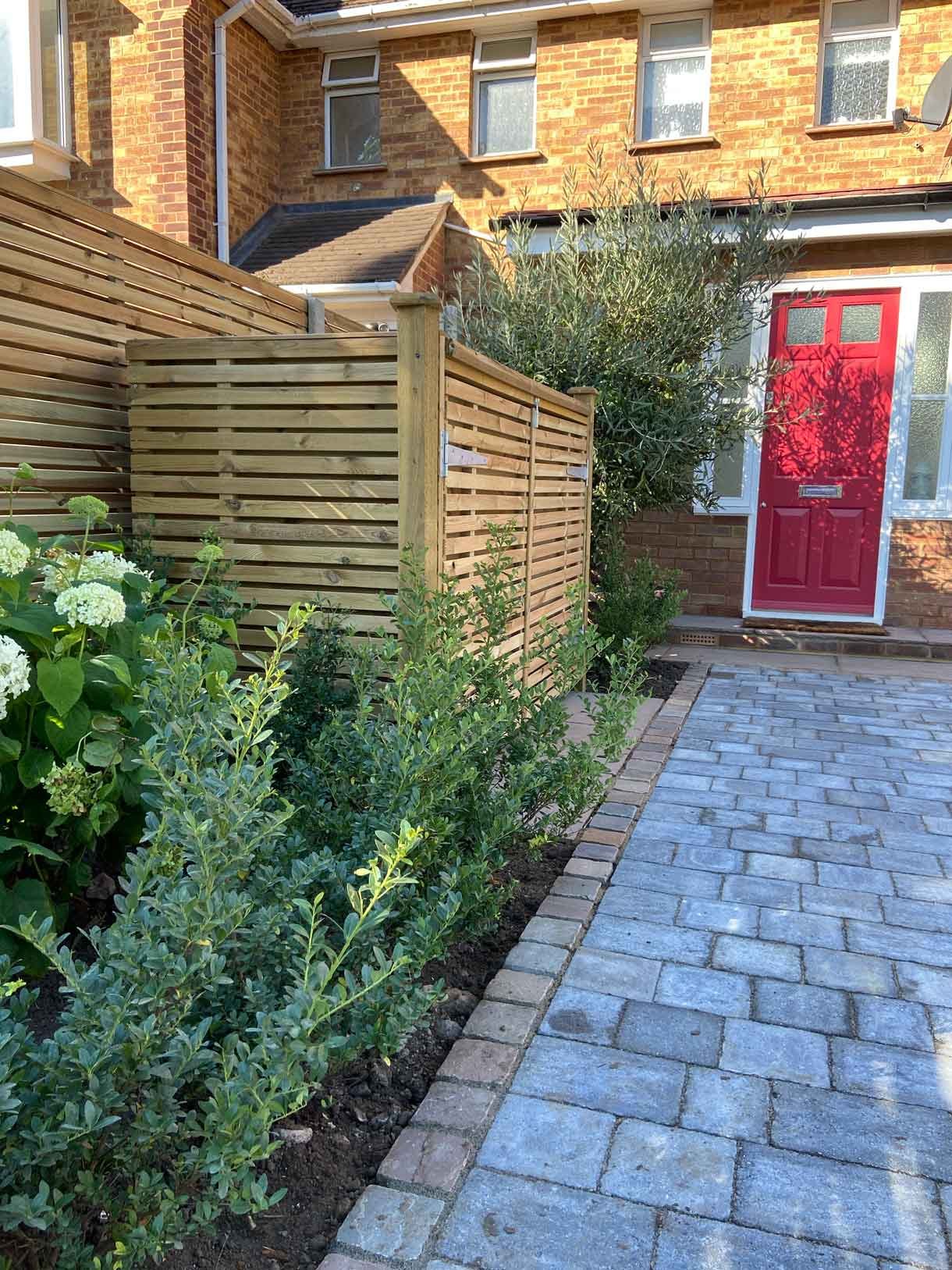 A new driveway with planting and bin storage in Surbiton.