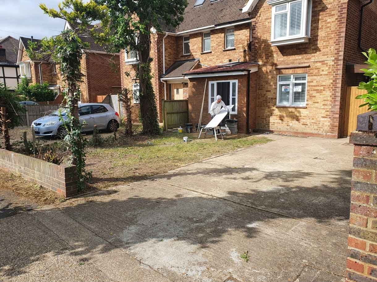 The driveway before the transformation, which was a mass of concrete and soil.