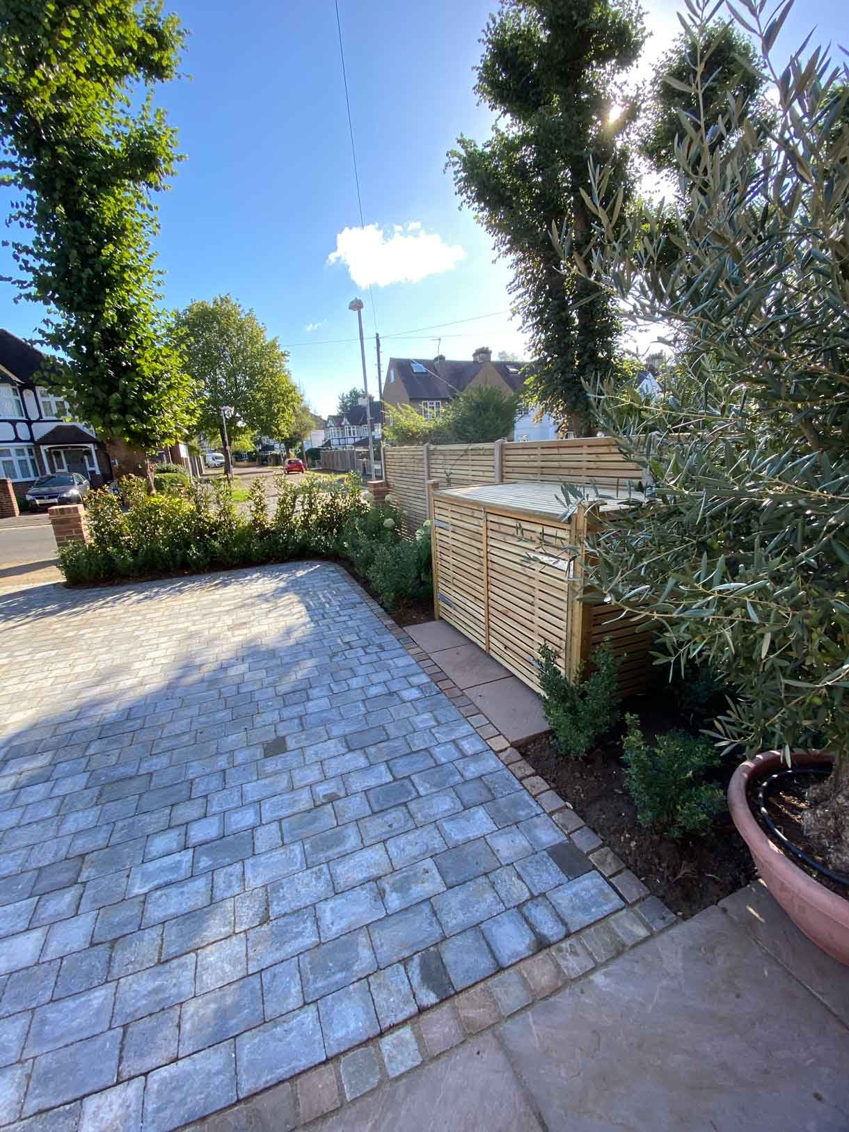 A new driveway with planting and bin storage in Surbiton.