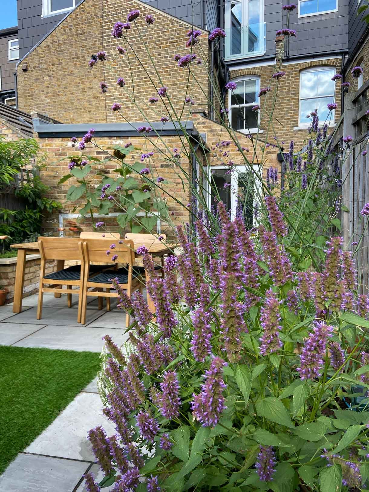 A small garden in Twickenham which we designed and built using sandstone for the patio and softwood sleepers for raised beds.