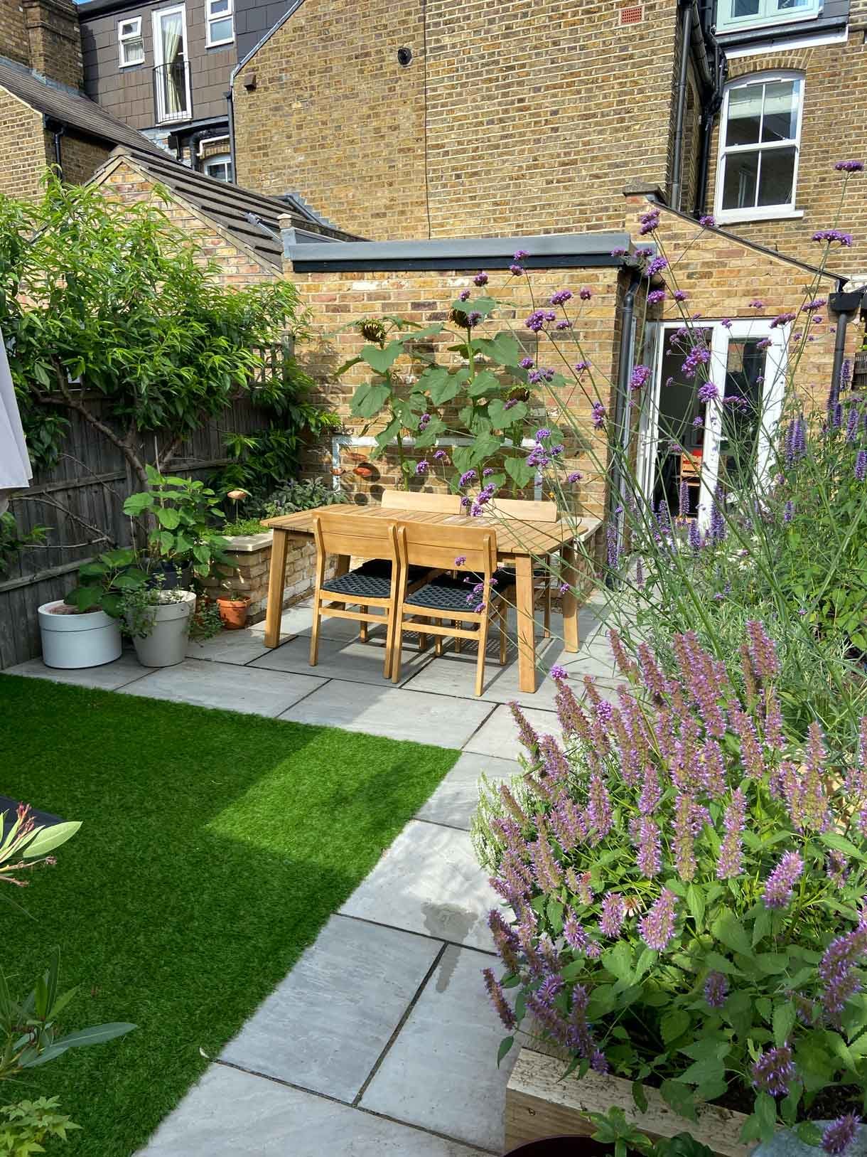 A small garden in Twickenham which we designed and built using sandstone for the patio and softwood sleepers for raised beds.