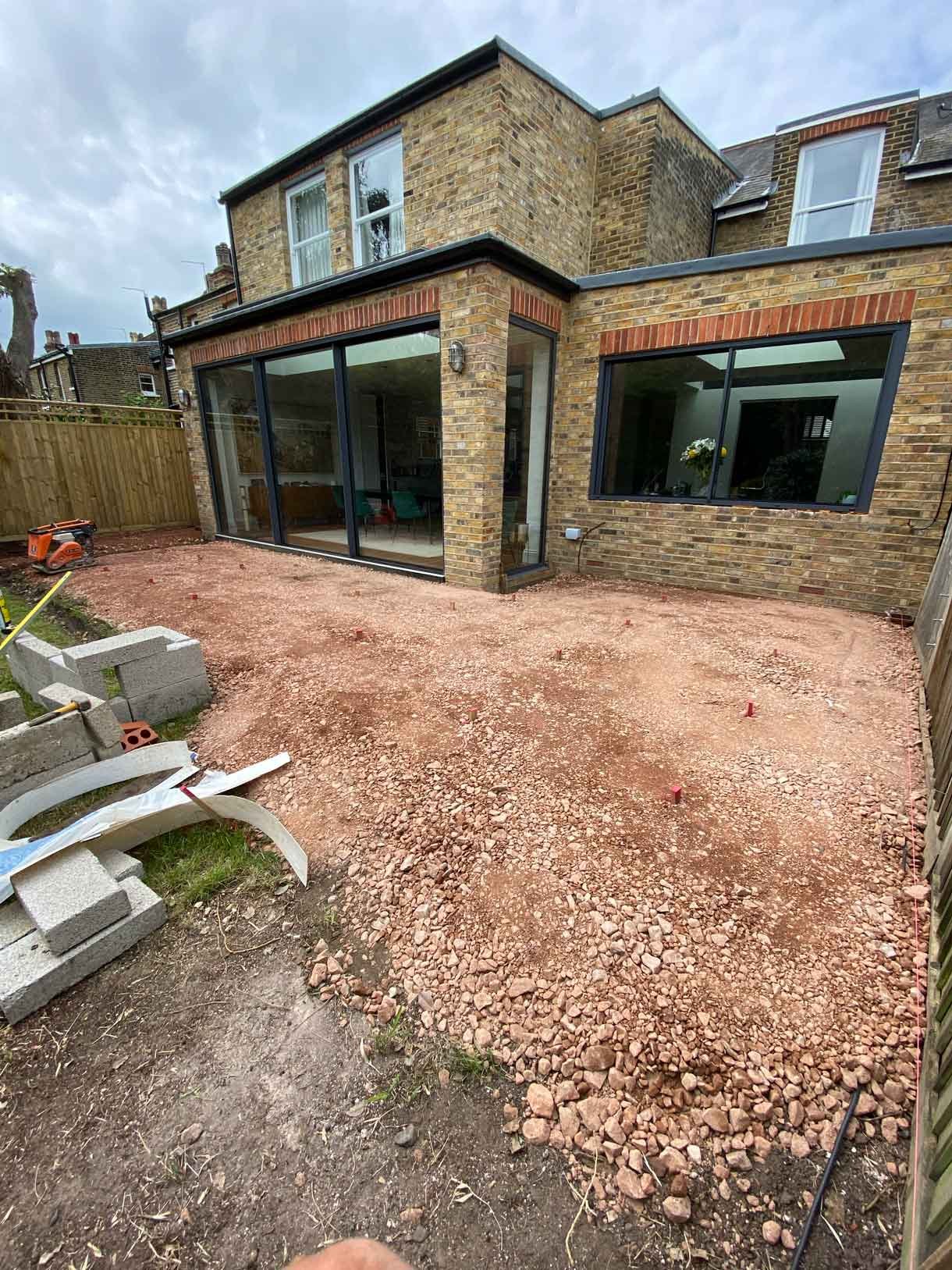 The area before the patio build with aggregate and building materials