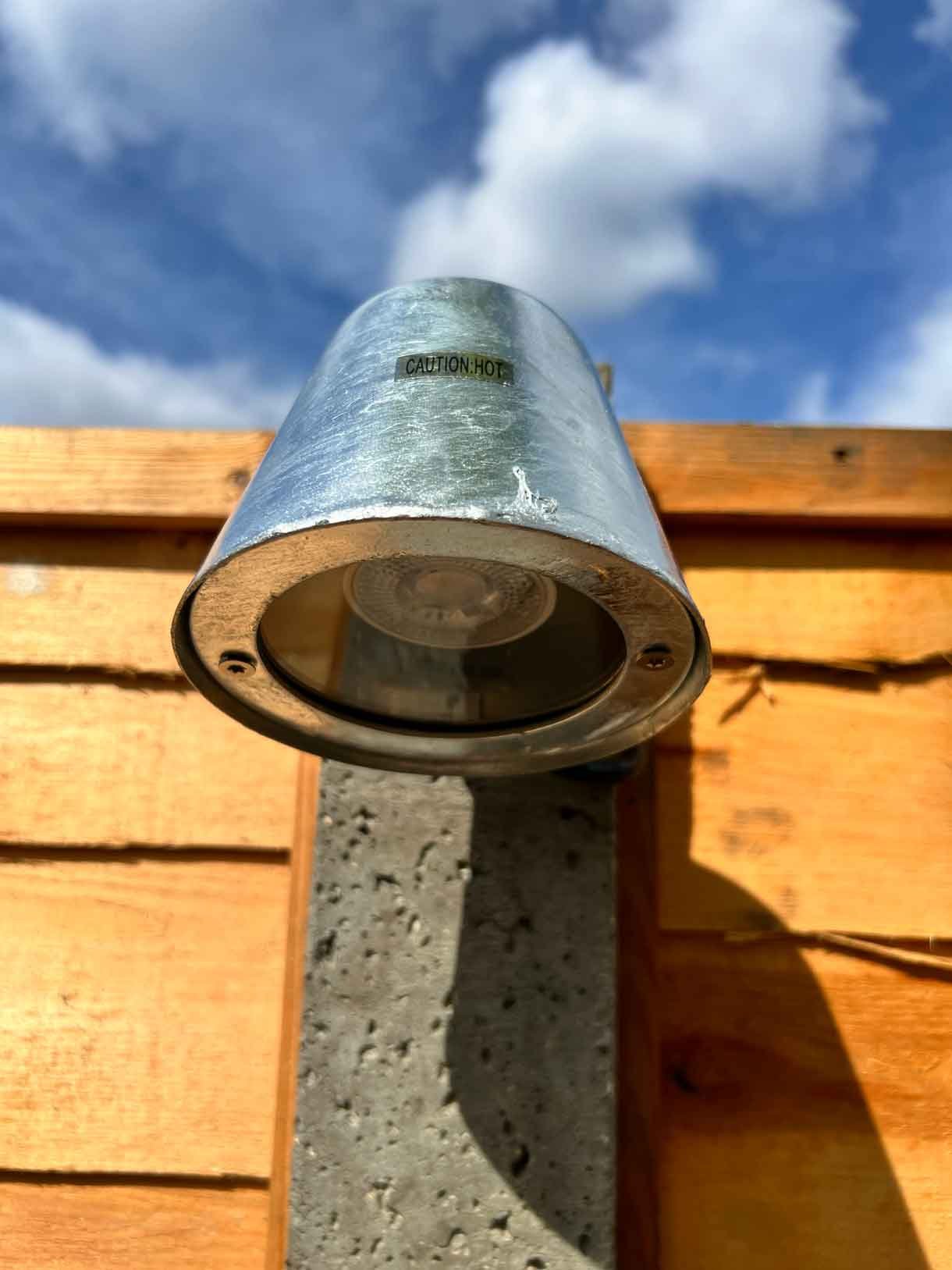A light detail attached to a concrete fence post