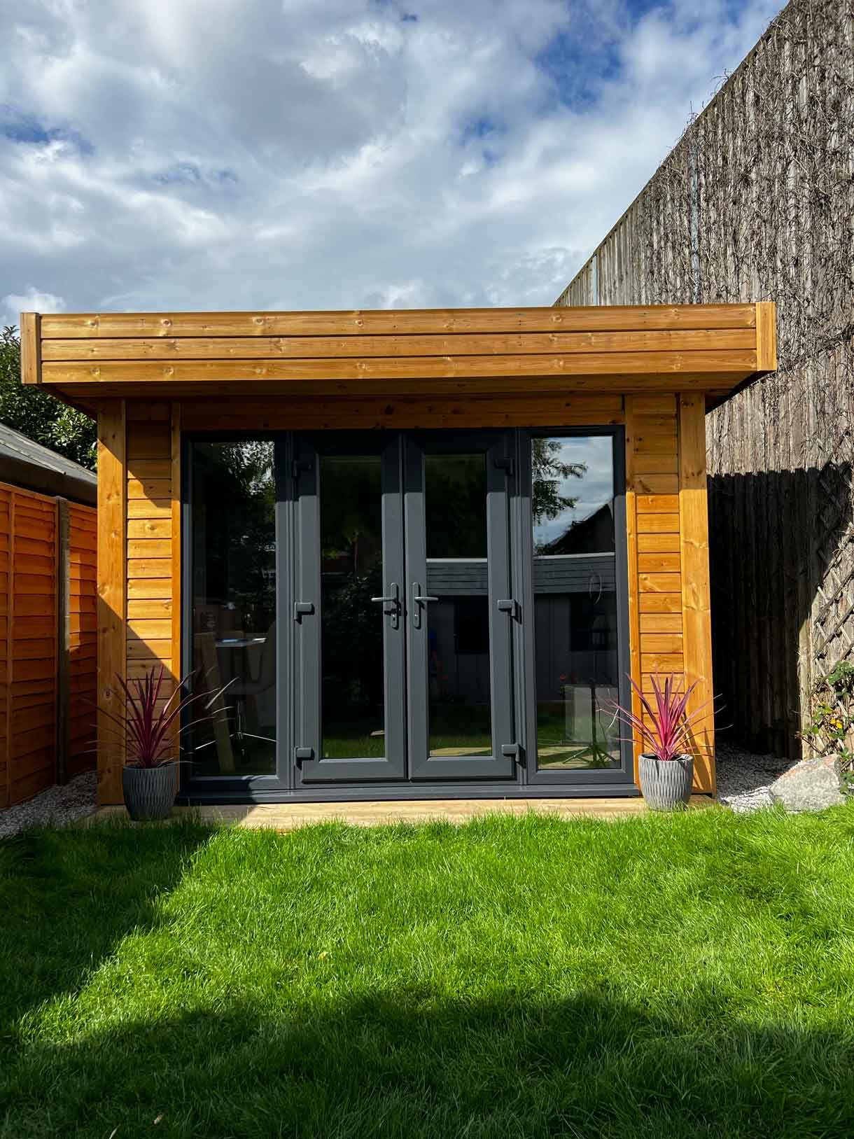 A long garden with stepping stones and lighting which leads to the new garden room at the bottom of the garden.