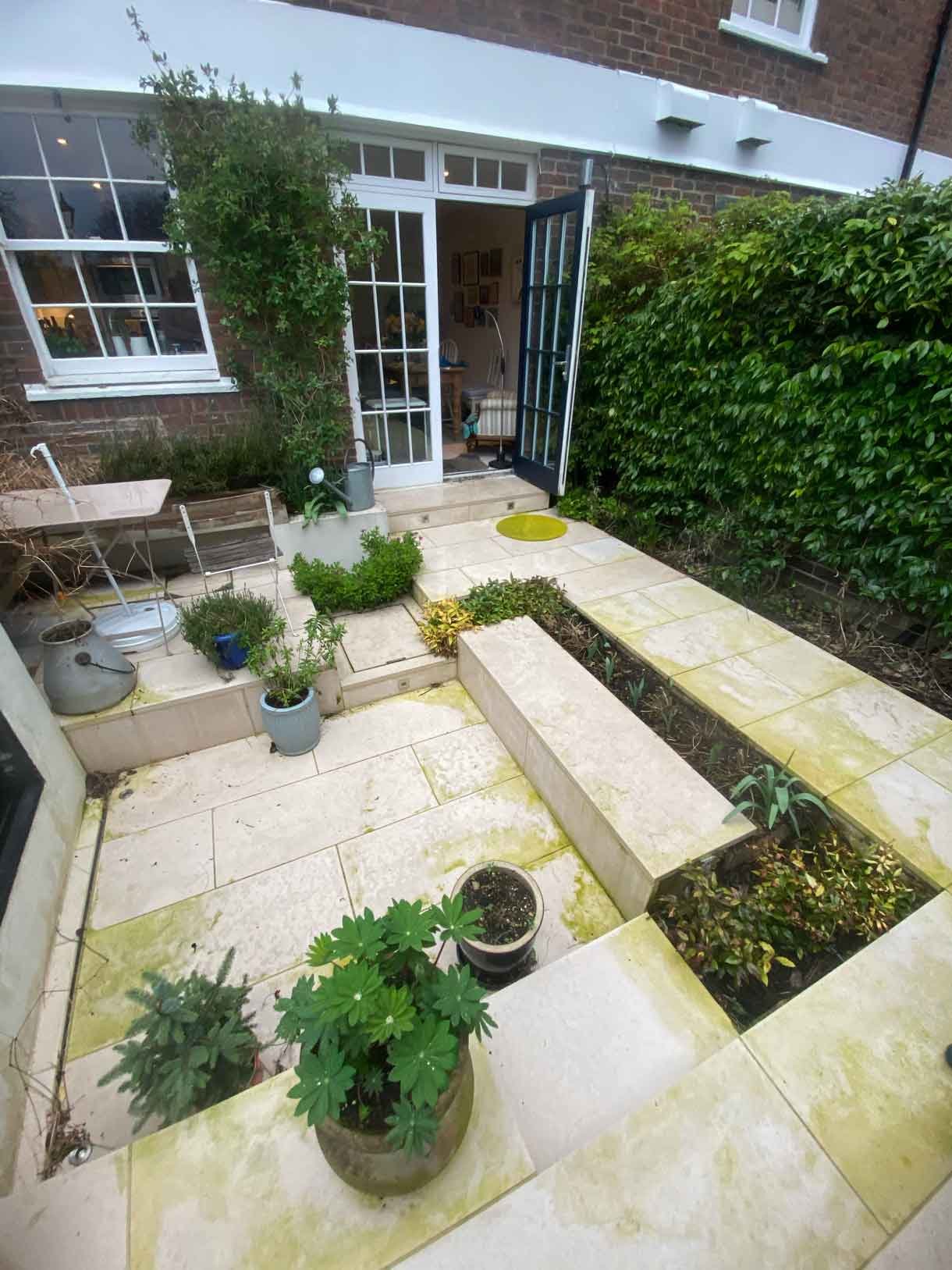 A small courtyard garden in Chiswick with raised planters.
