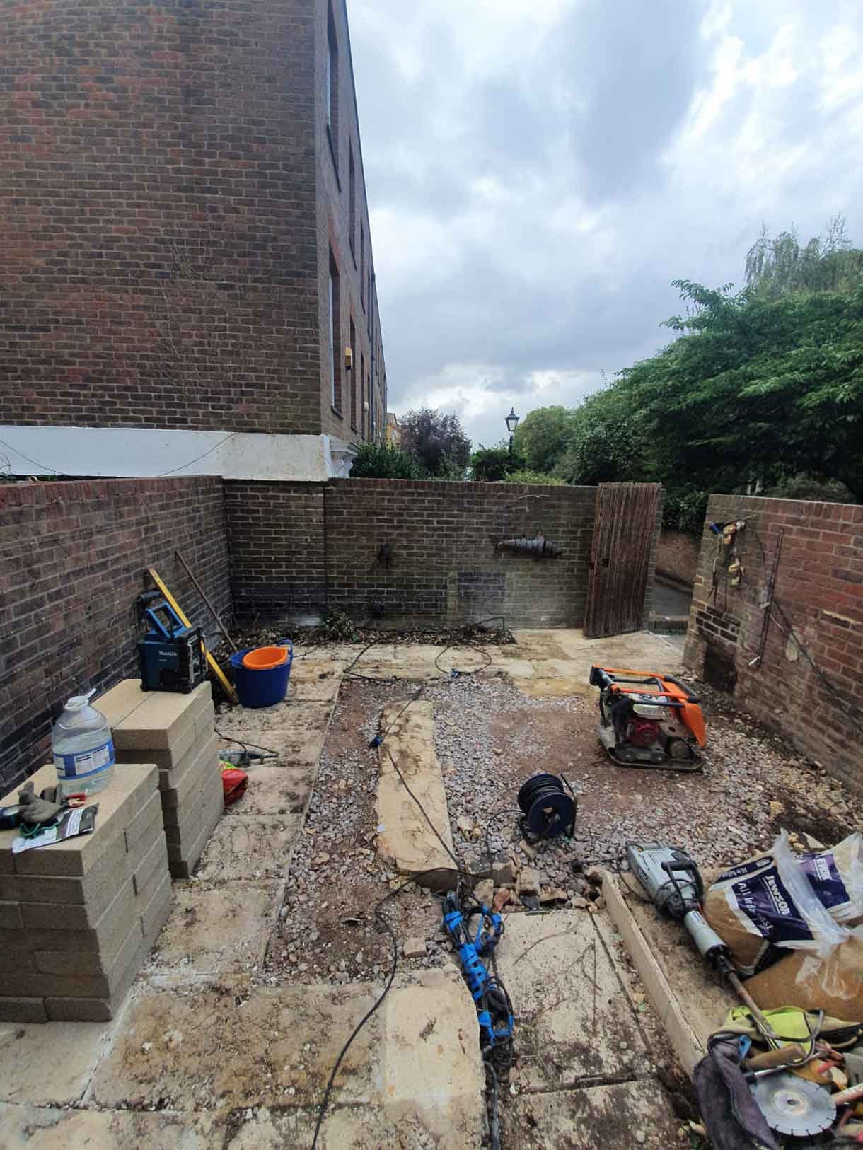 A small courtyard garden in Chiswick with raised planters.