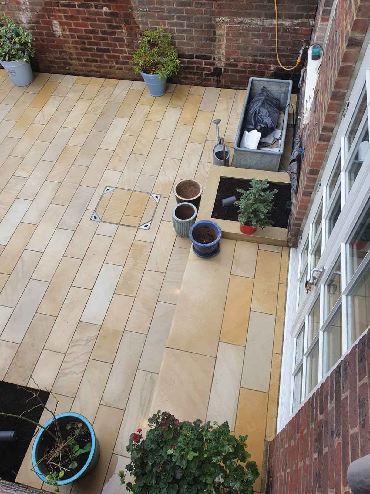 A small courtyard garden in Chiswick with raised planters.