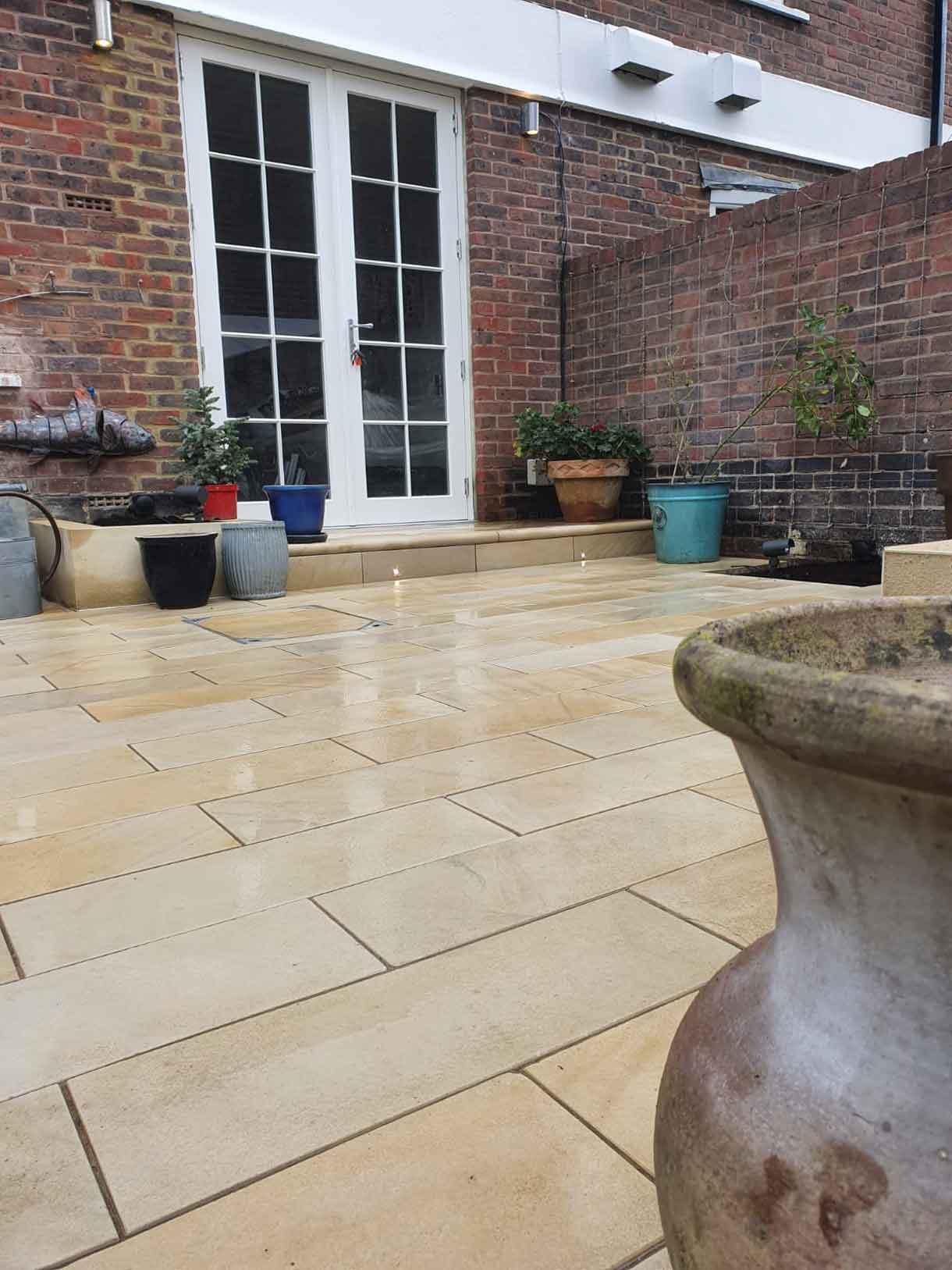 A small courtyard garden in Chiswick with raised planters.