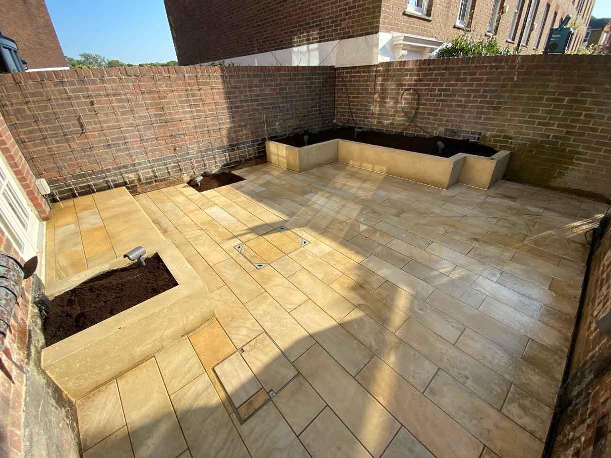 A small courtyard garden in Chiswick with raised planters.
