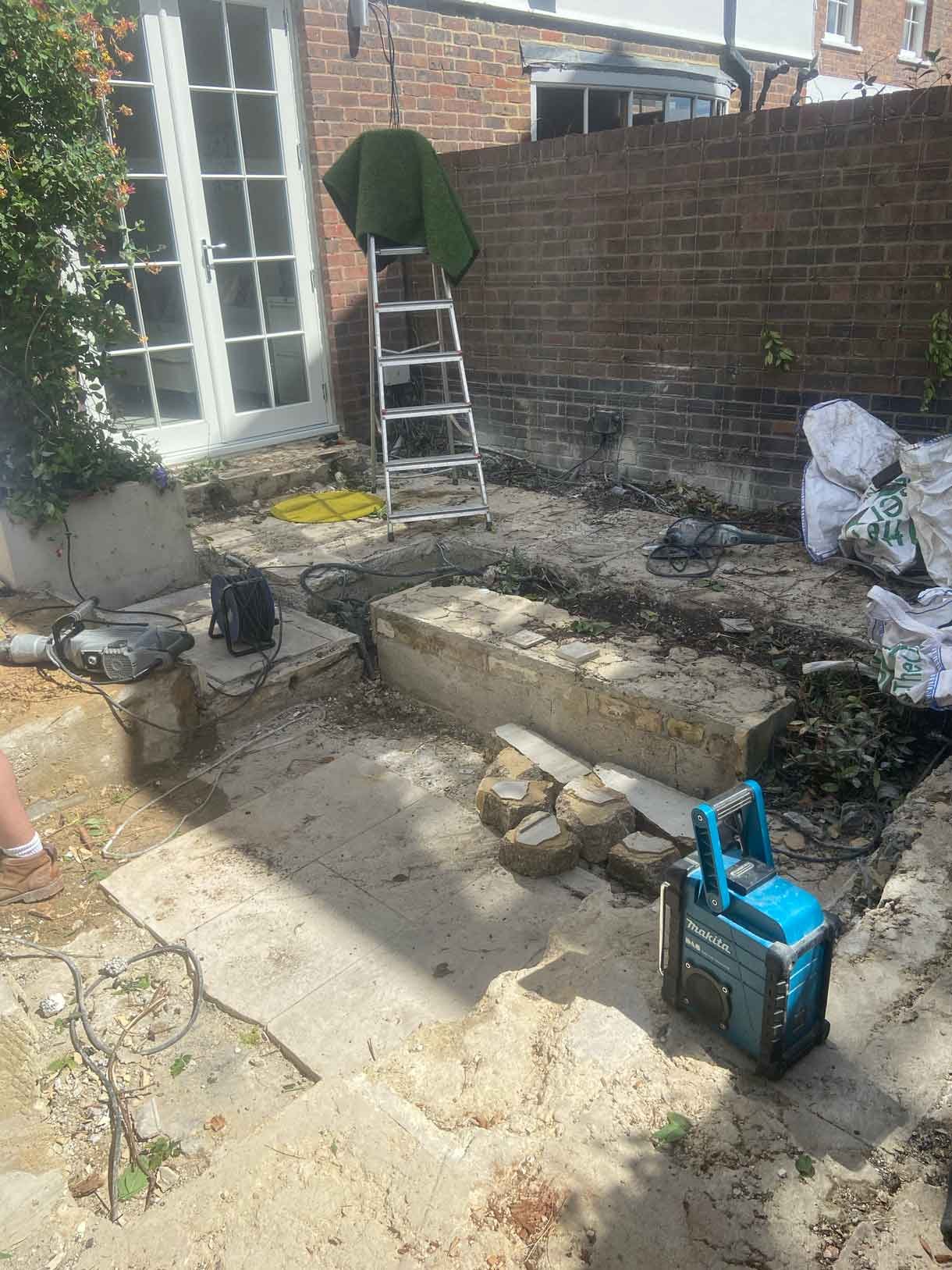 A small courtyard garden in Chiswick with raised planters.