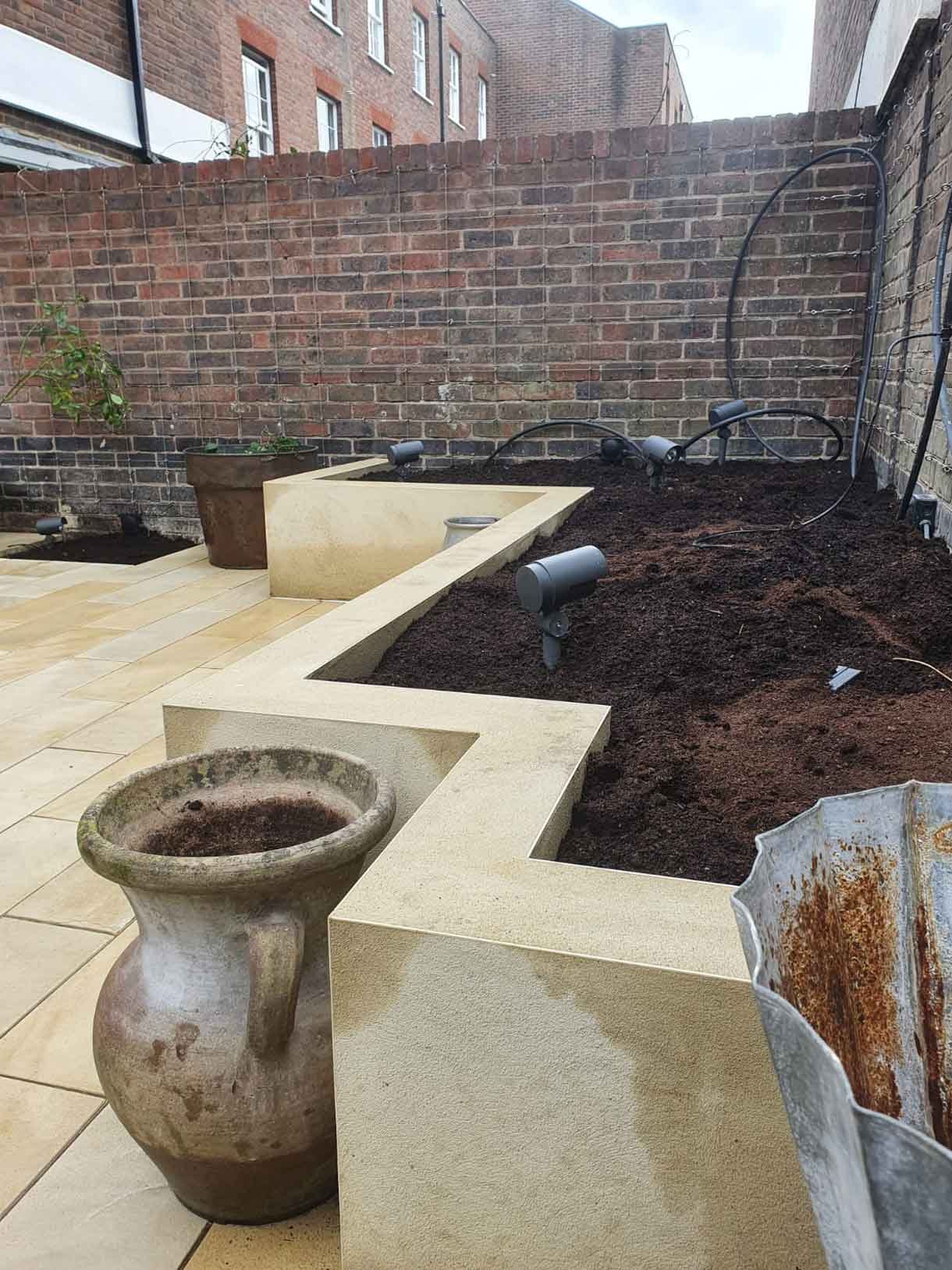 A small courtyard garden in Chiswick with raised planters.