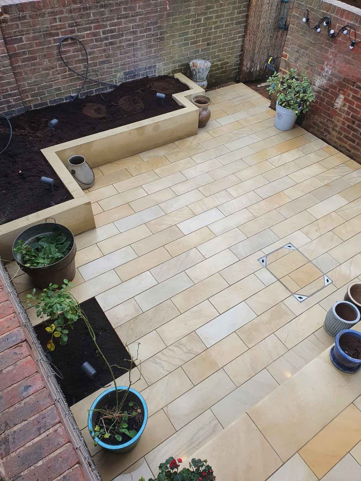 A small courtyard garden in Chiswick with raised planters.